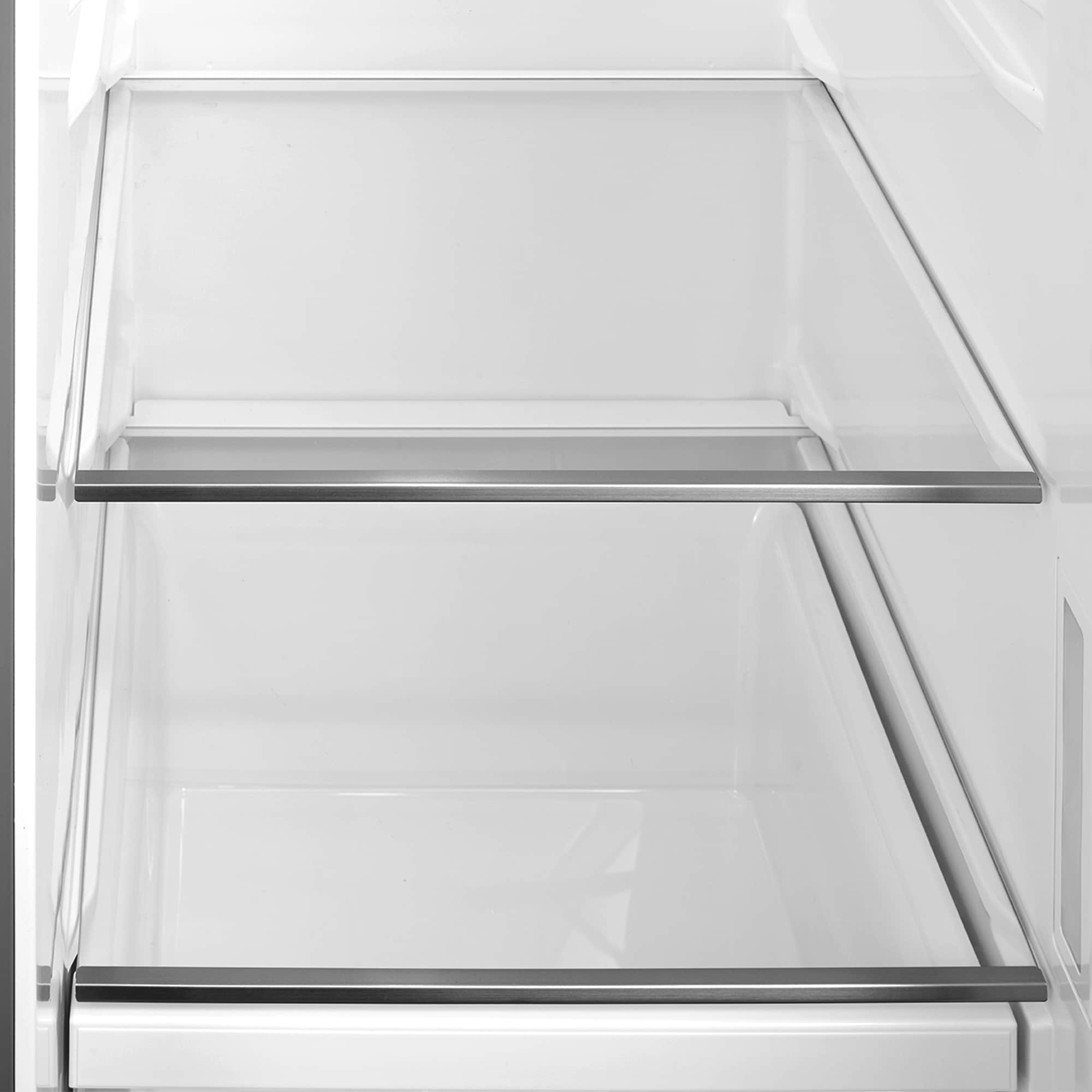 Empty refrigerator freezer compartment with glass shelves and drawers