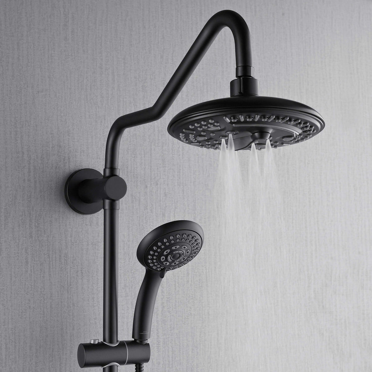 Matte black overhead rainfall head with handheld sprayer and directional body jets, water flowing