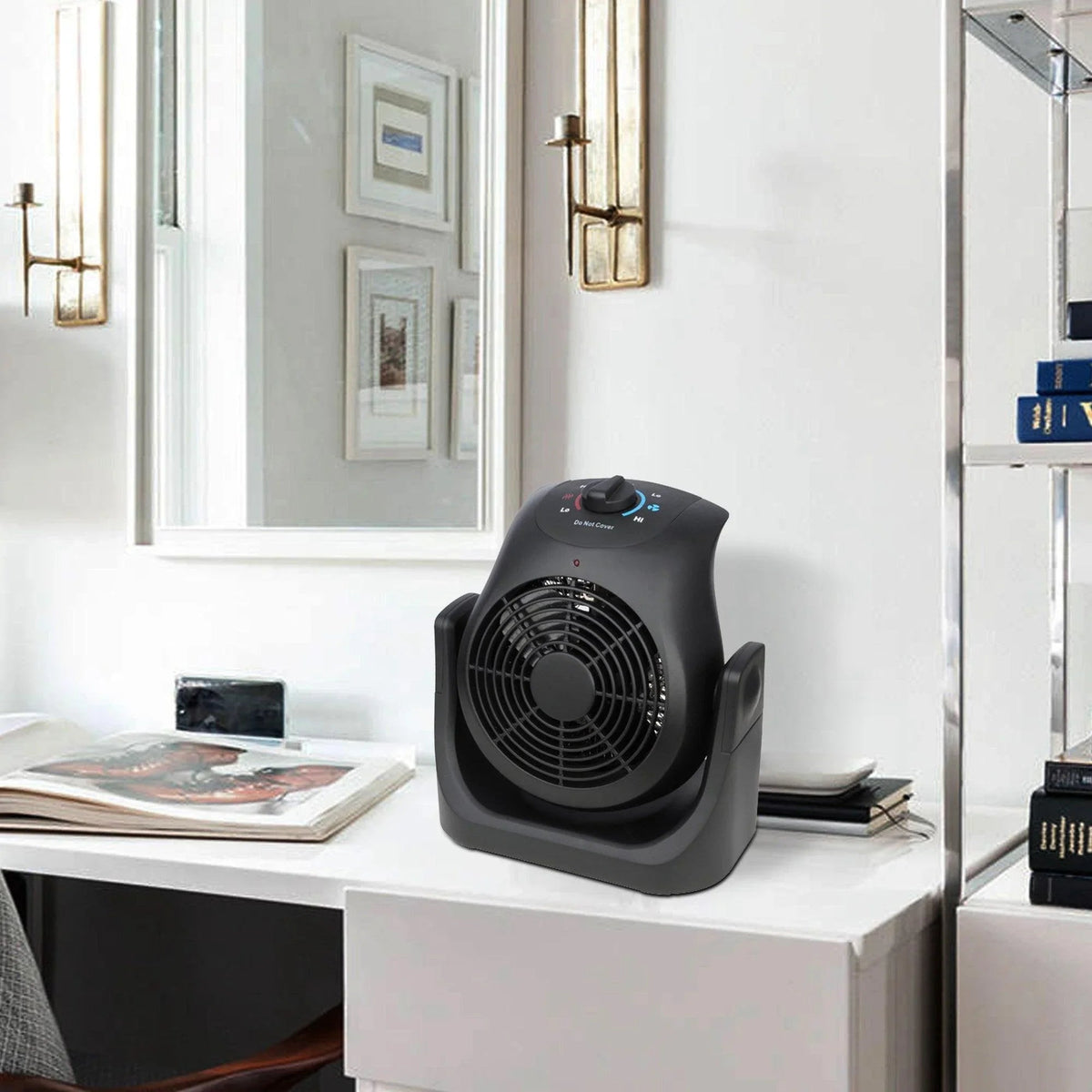 Black portable electric heater with fan, top control knob and front vents