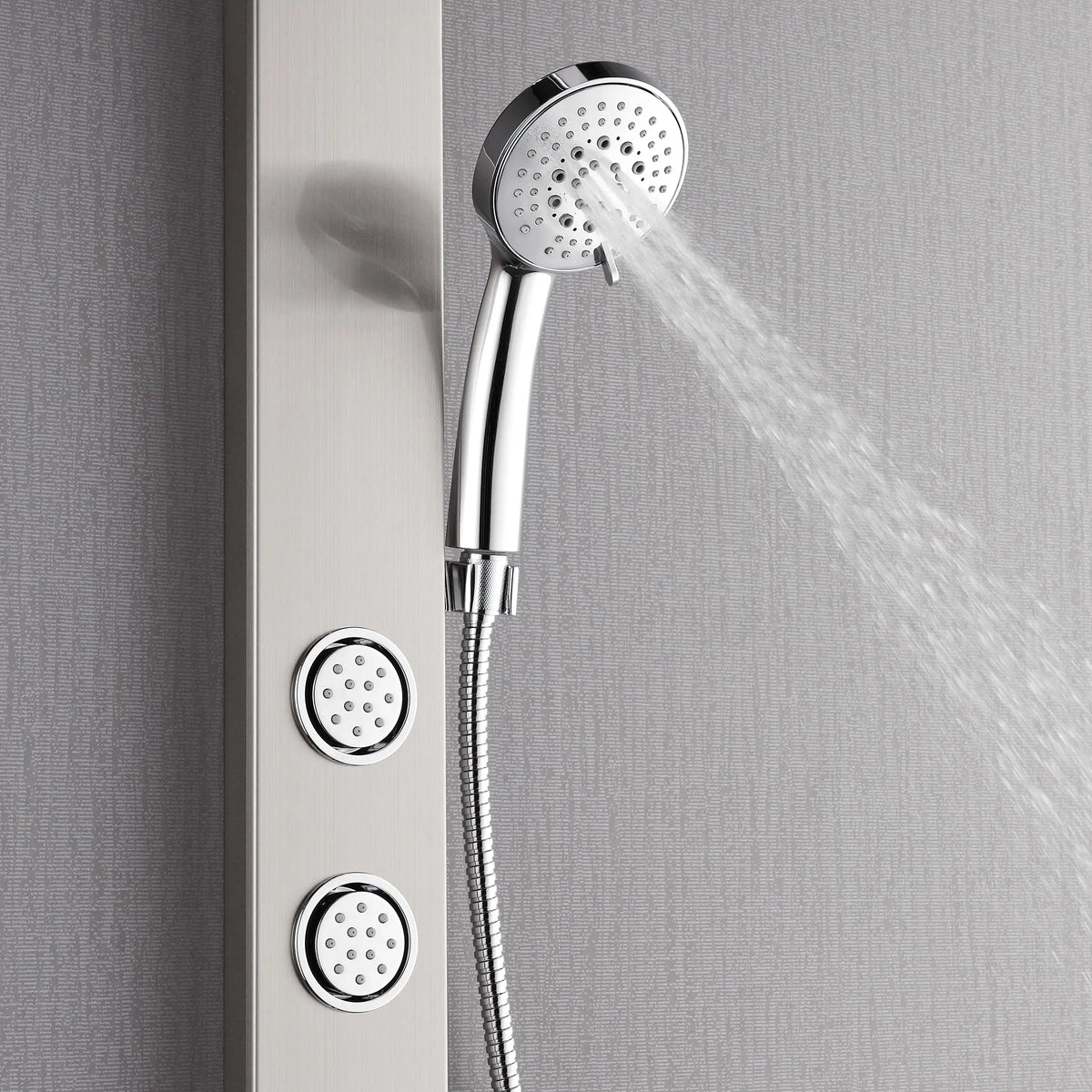 Stainless steel rainfall head and handheld sprayer spraying water from wall shower panel
