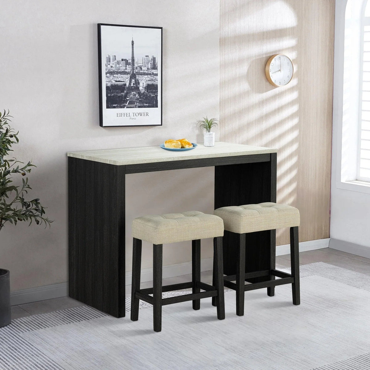 Black dining table set with two beige stools and travertine-look table top