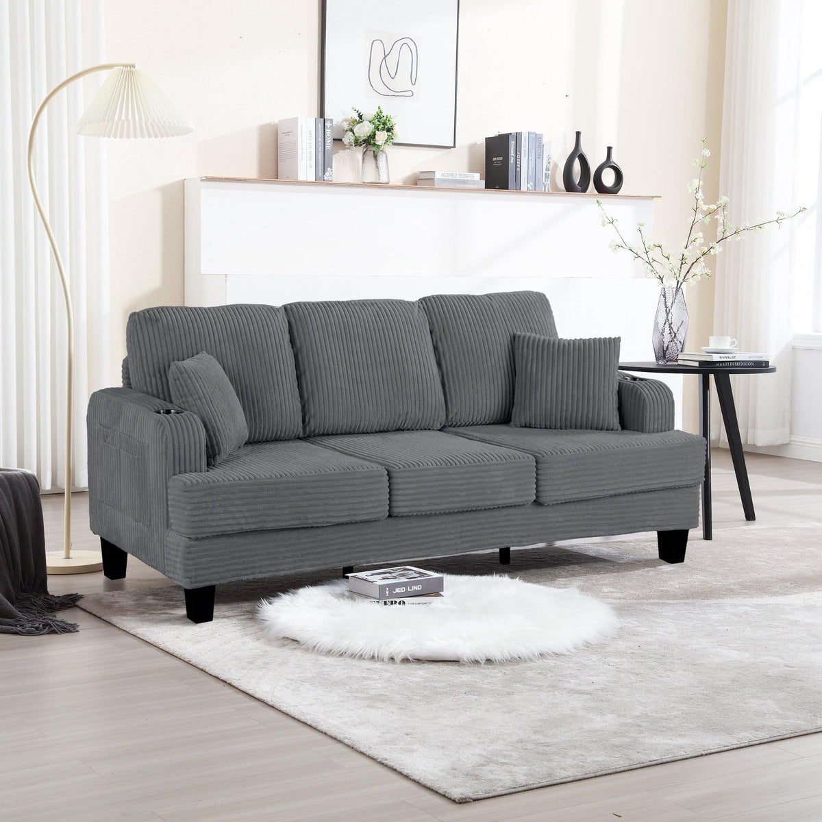 Dark gray corduroy 3-seater sofa with three back cushions and plush seat cushions