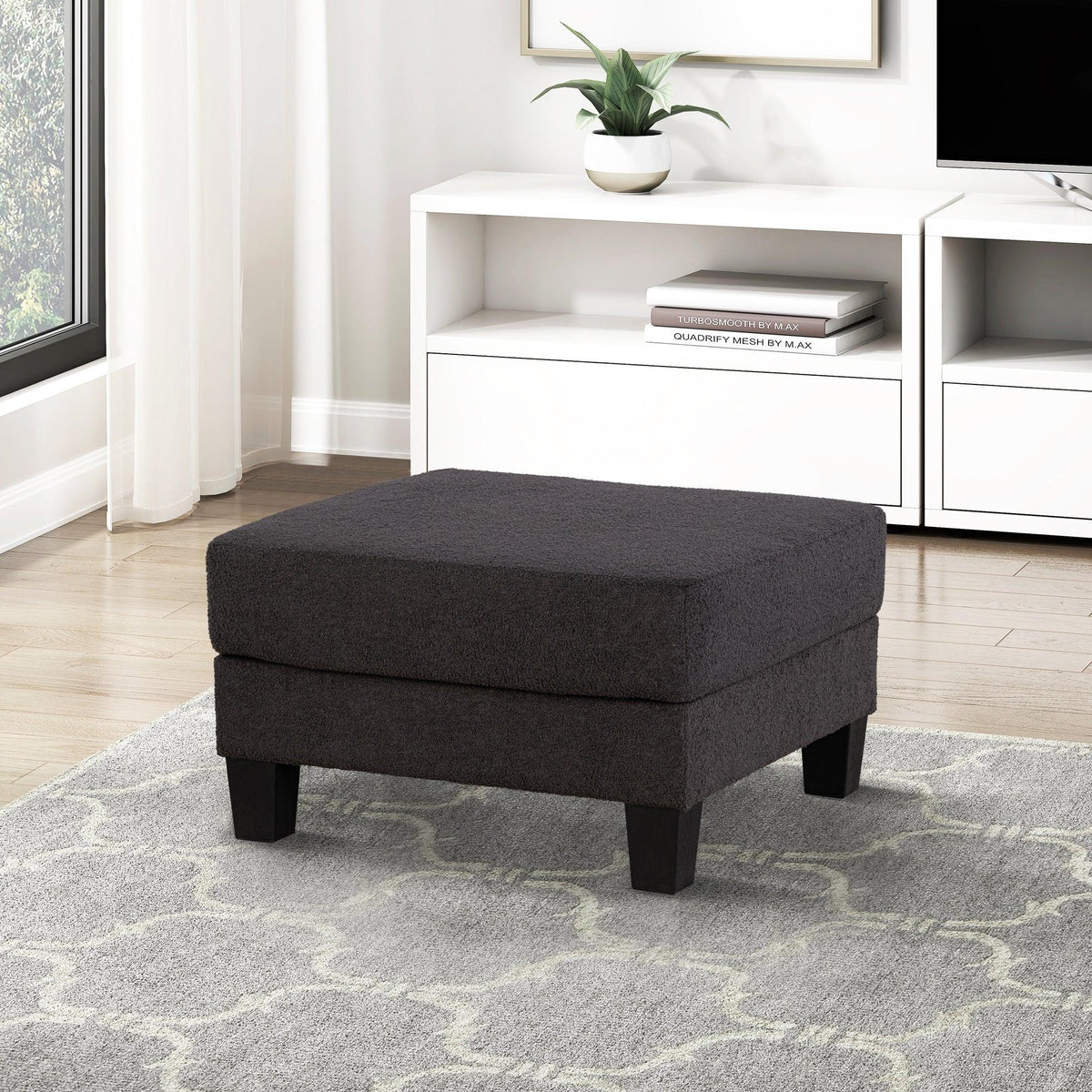Dark gray storage ottoman with thick padded top and short legs