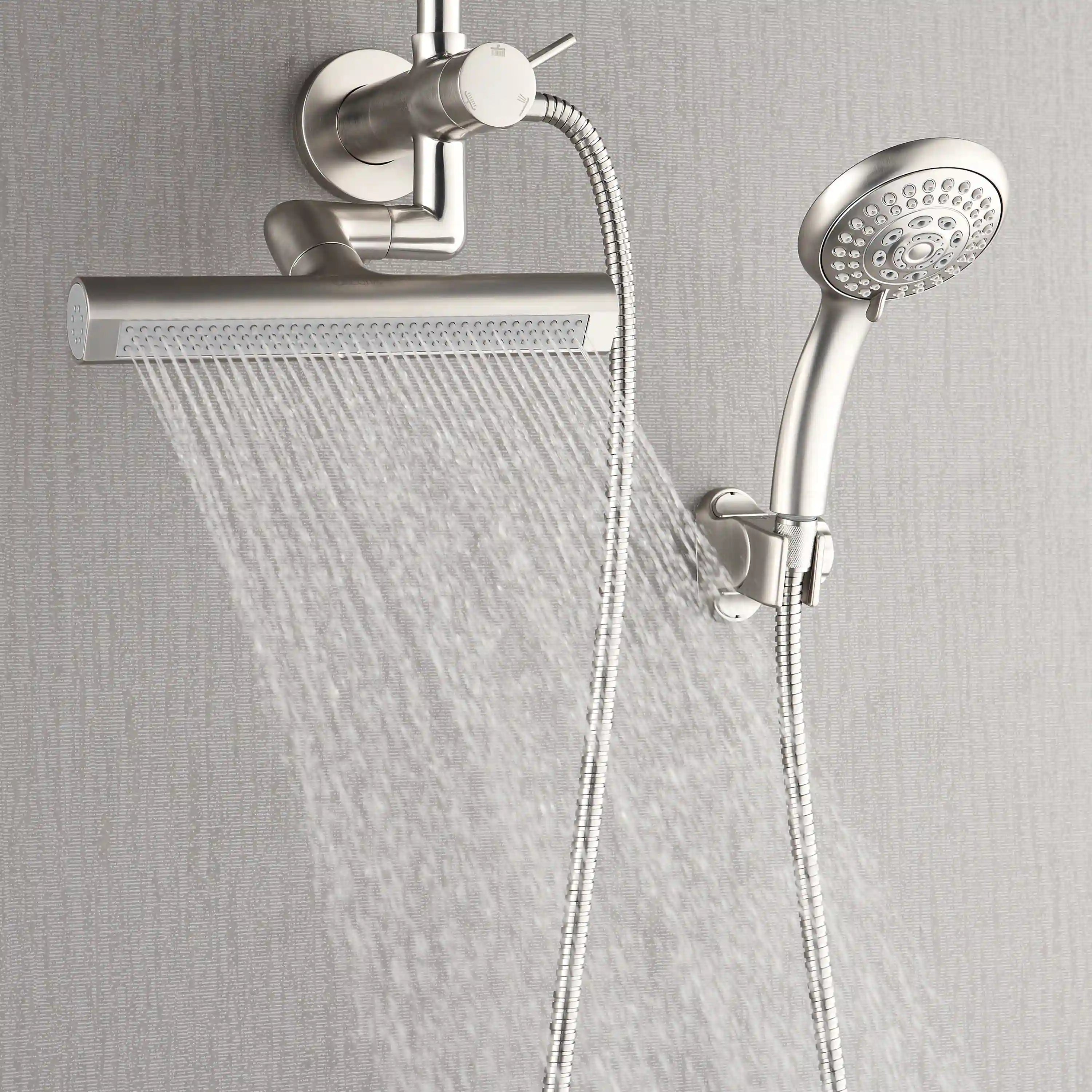 Brushed nickel overhead rainfall head and handheld shower with hoses on wall mount.