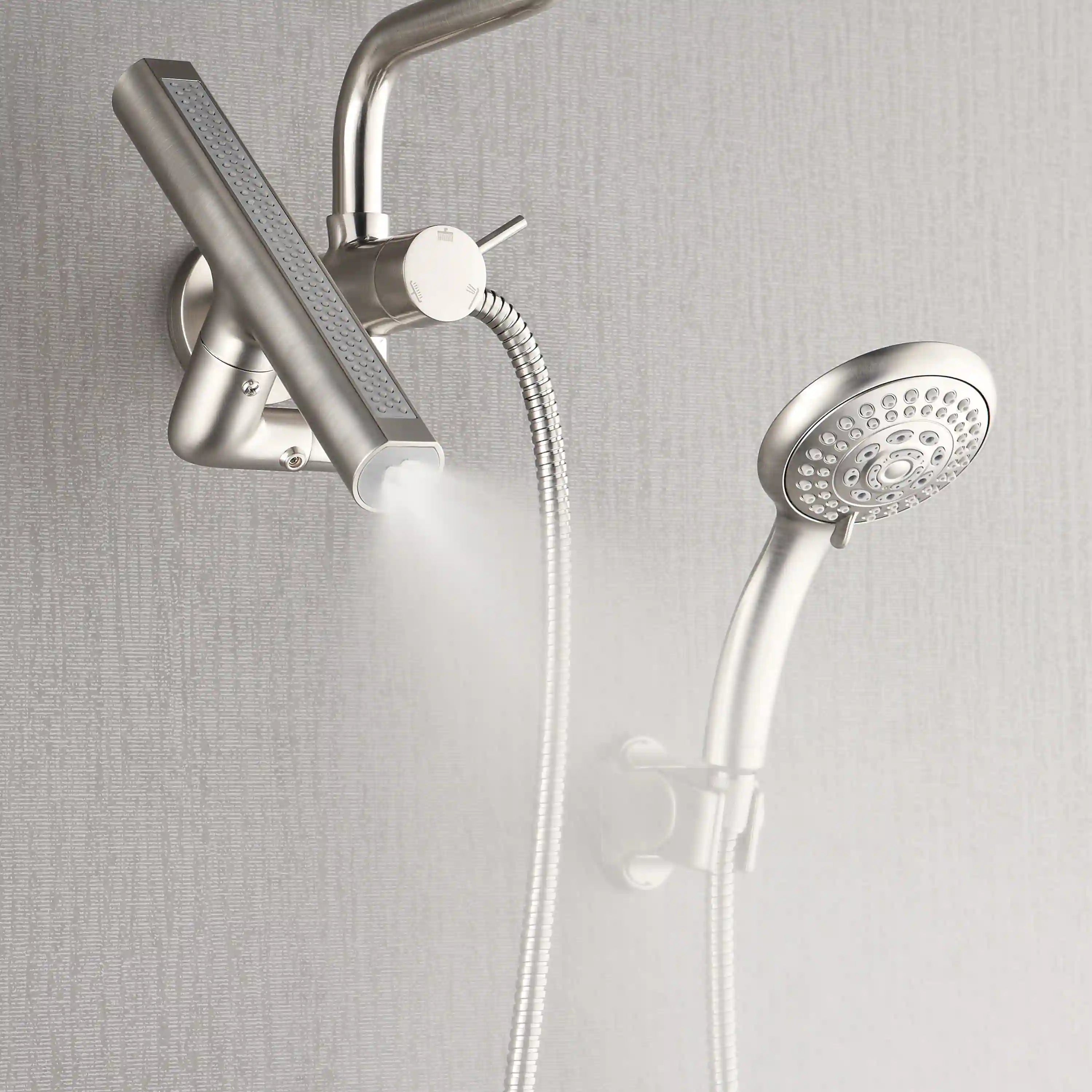 Brushed nickel shower system showing overhead rain head and handheld sprayer with spray