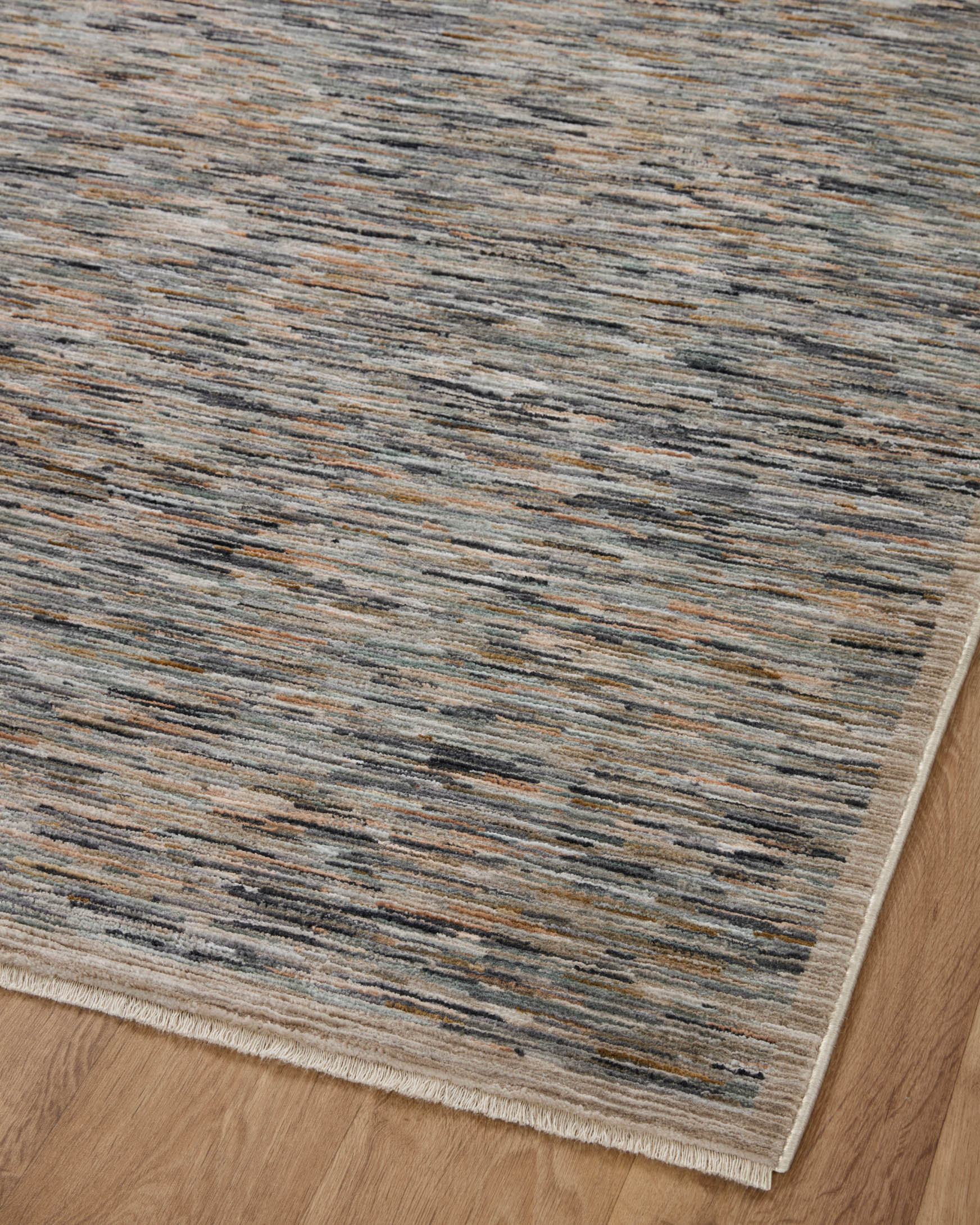 Corner view of contemporary area rug with short pile and speckled blue-gray stripe pattern