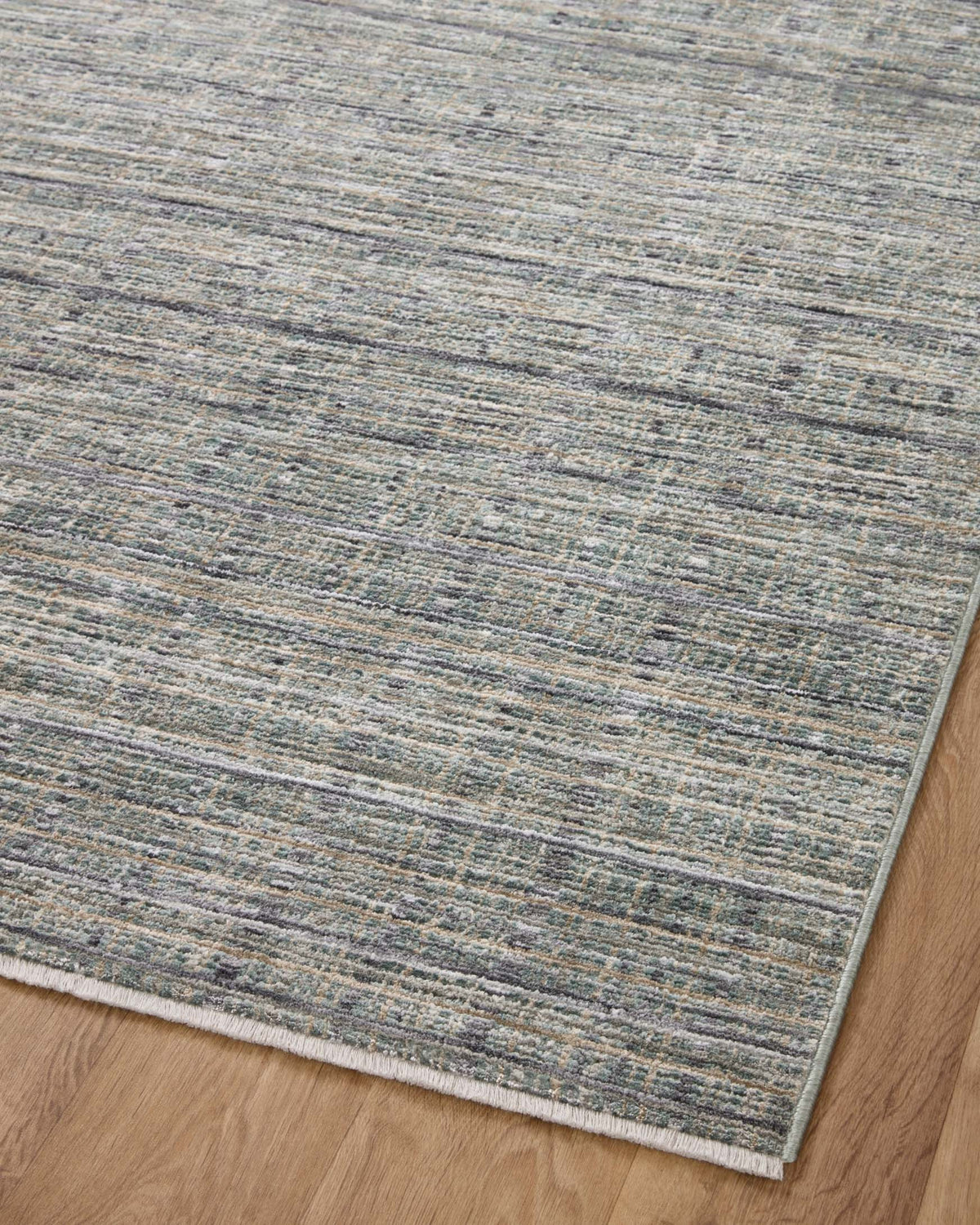 Blue-gray area rug with layered distressed stripe pattern and straight bound edges