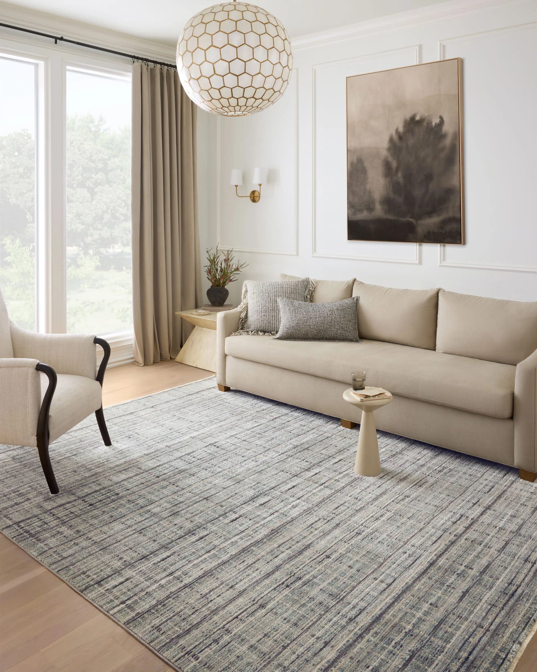 Accent rug with textured blue-gray and light green bands, visible rectangular border