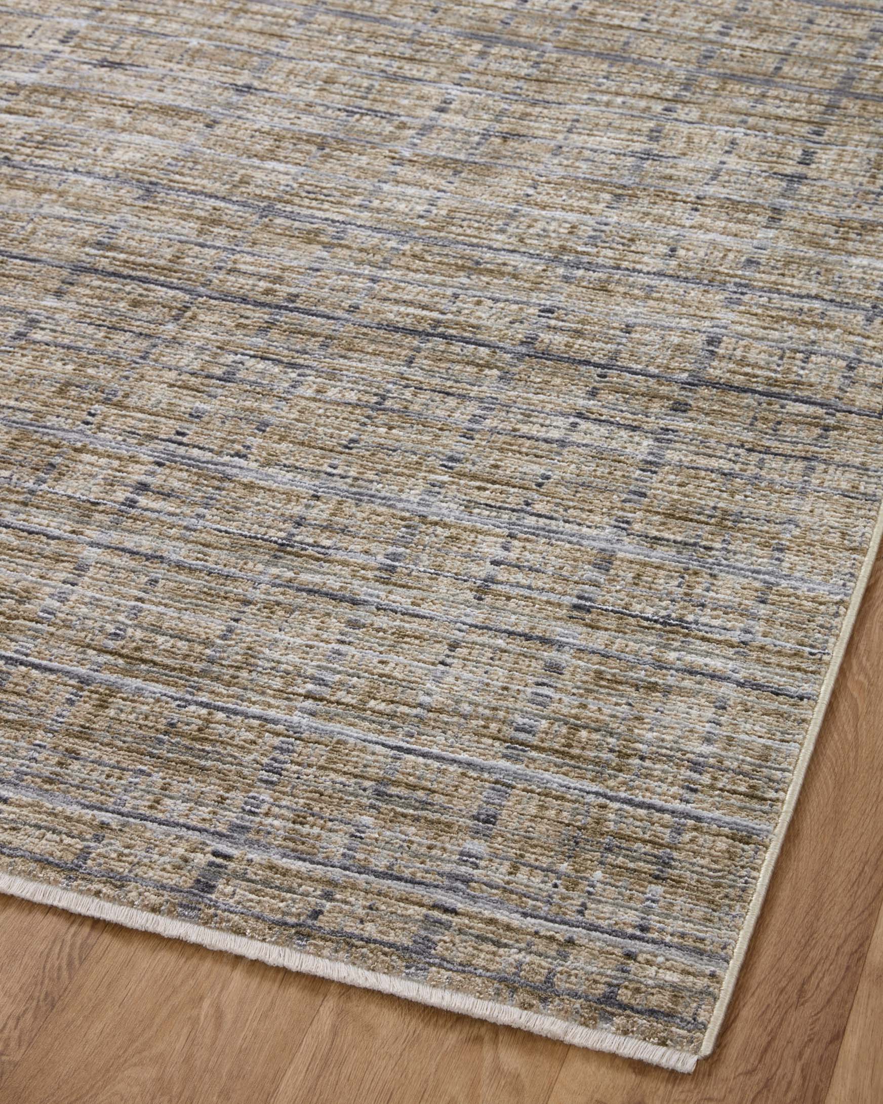 Area rug with pebble pattern and thin grid lines in beige, charcoal, and blue-gray