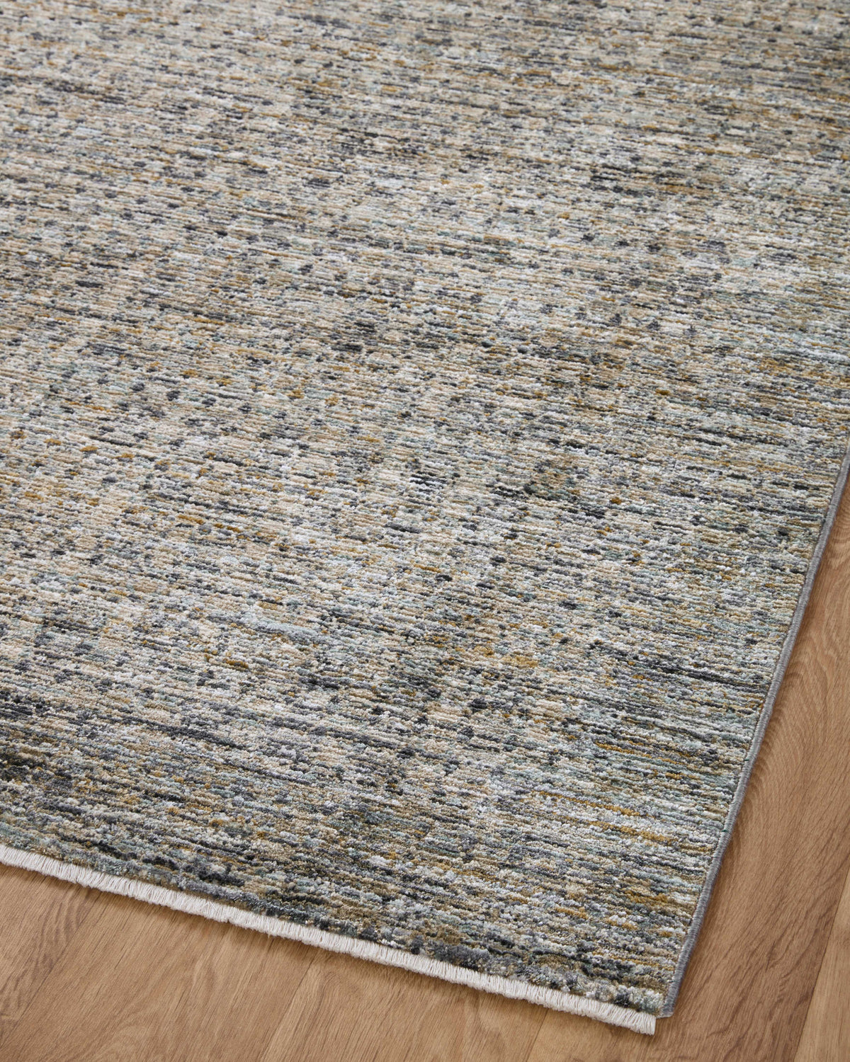 Diagonal view of charcoal and cream flat weave area rug with flecked linear pattern