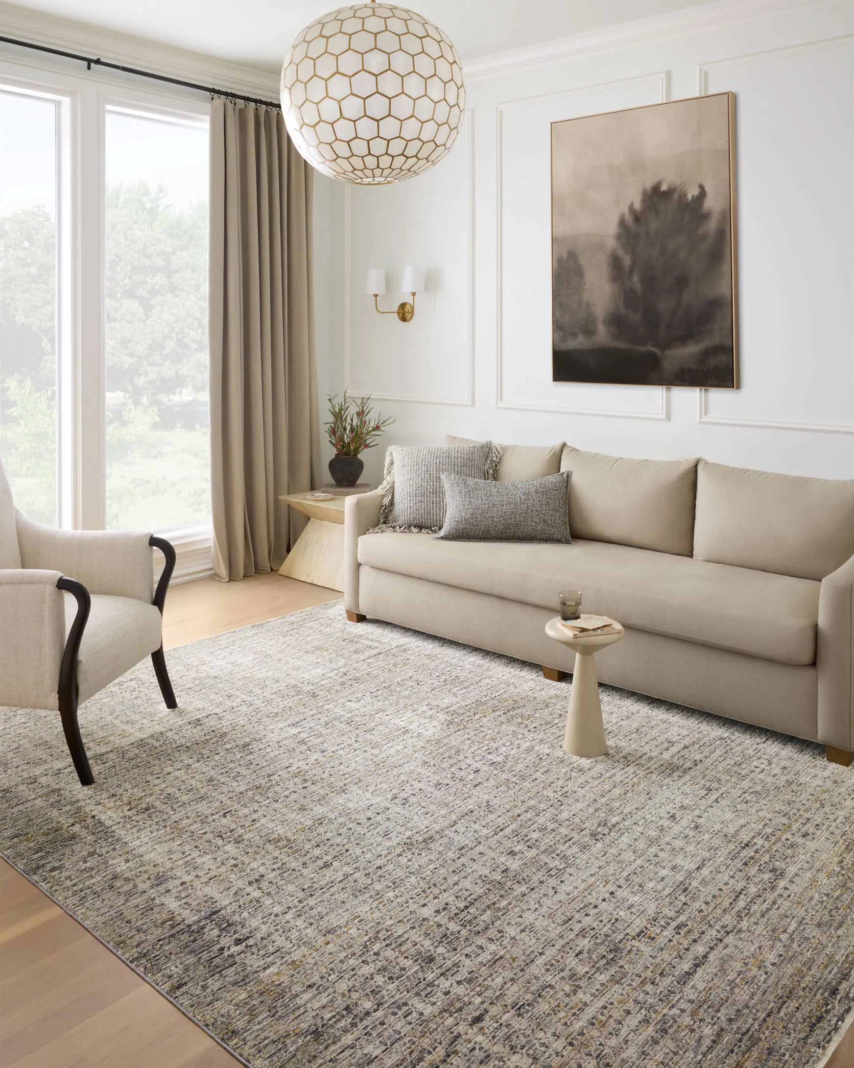 Multicolor rectangular accent rug in gray and charcoal tones under living room seating