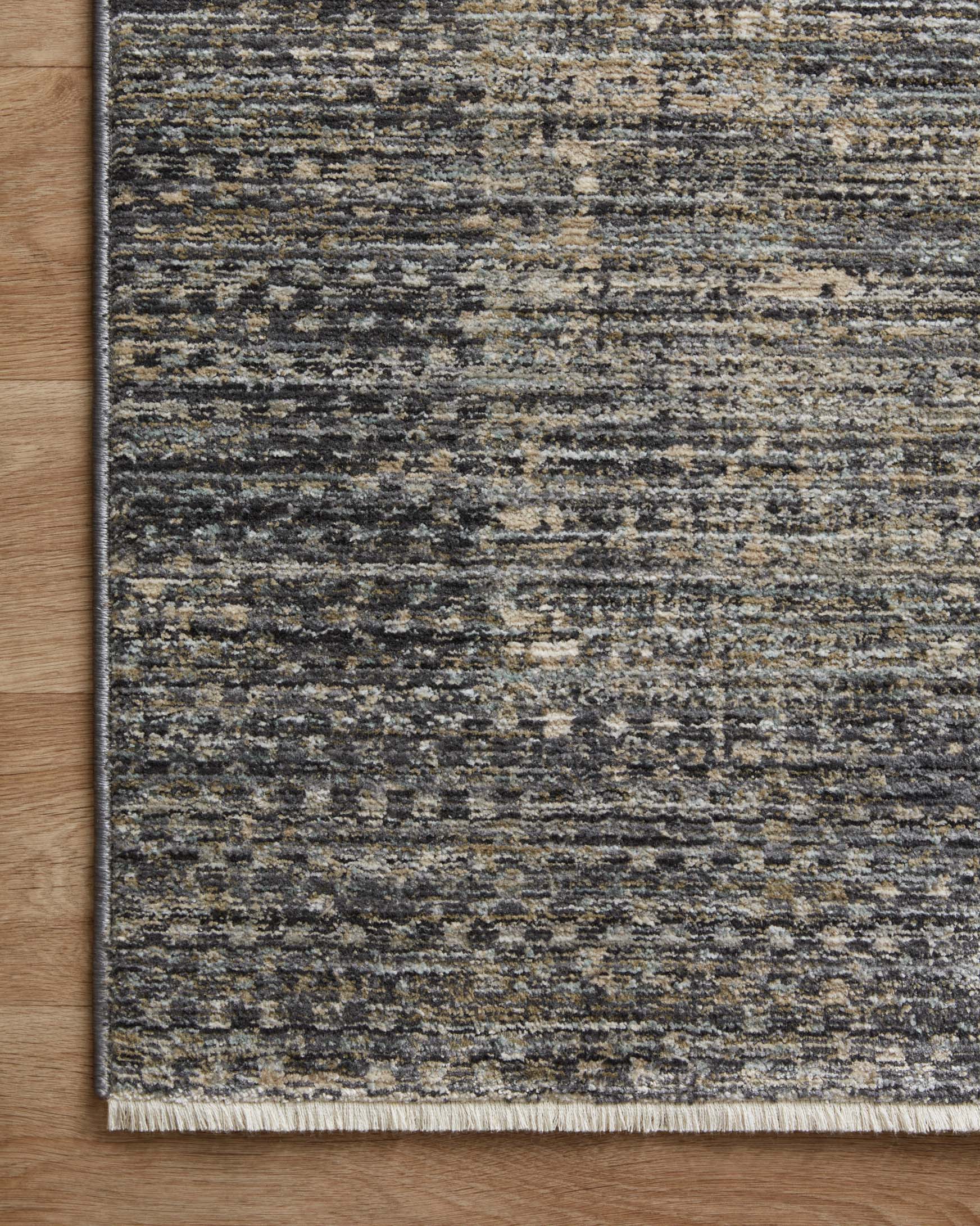 Slate gray area rug with speckled abstract horizontal pattern and stitched perimeter border.