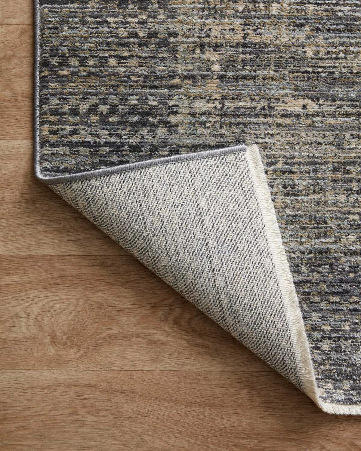 Slate gray runner rug corner showing edge binding and woven backing texture