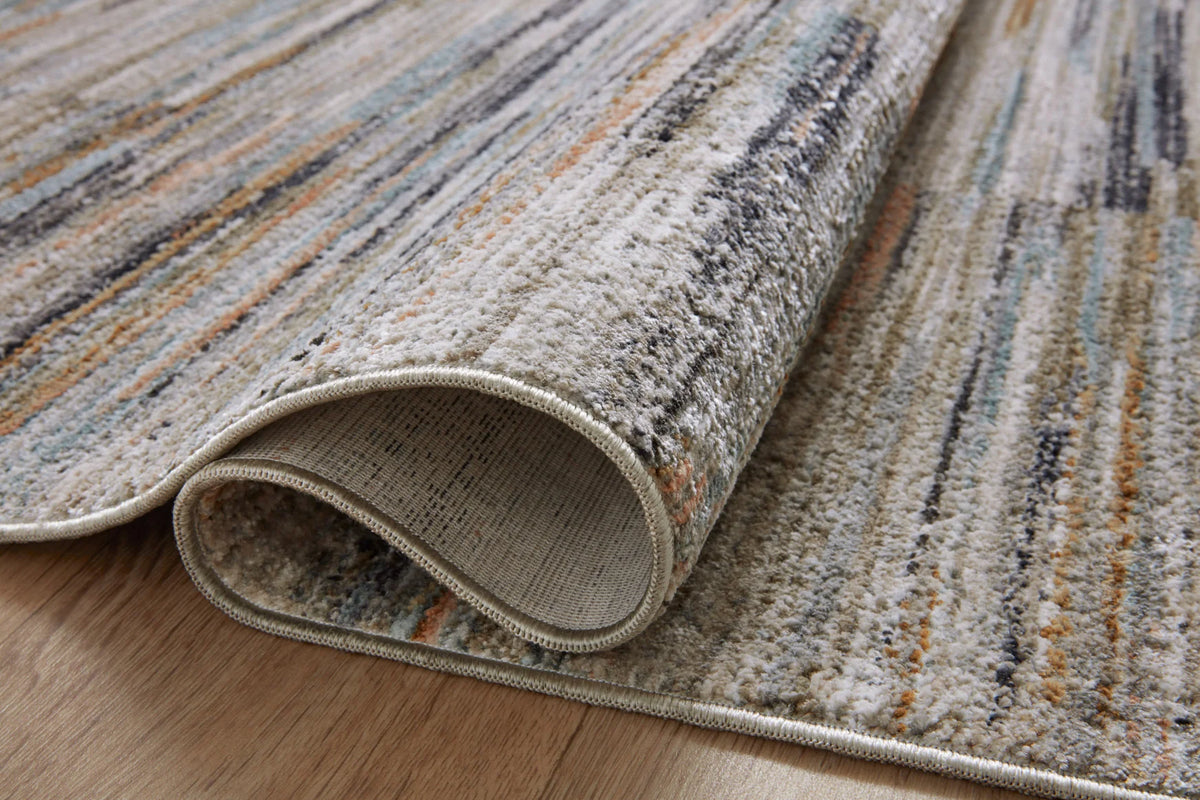 Contemporary area rug with rolled edge, showing woven texture and gray-blue stripe pattern