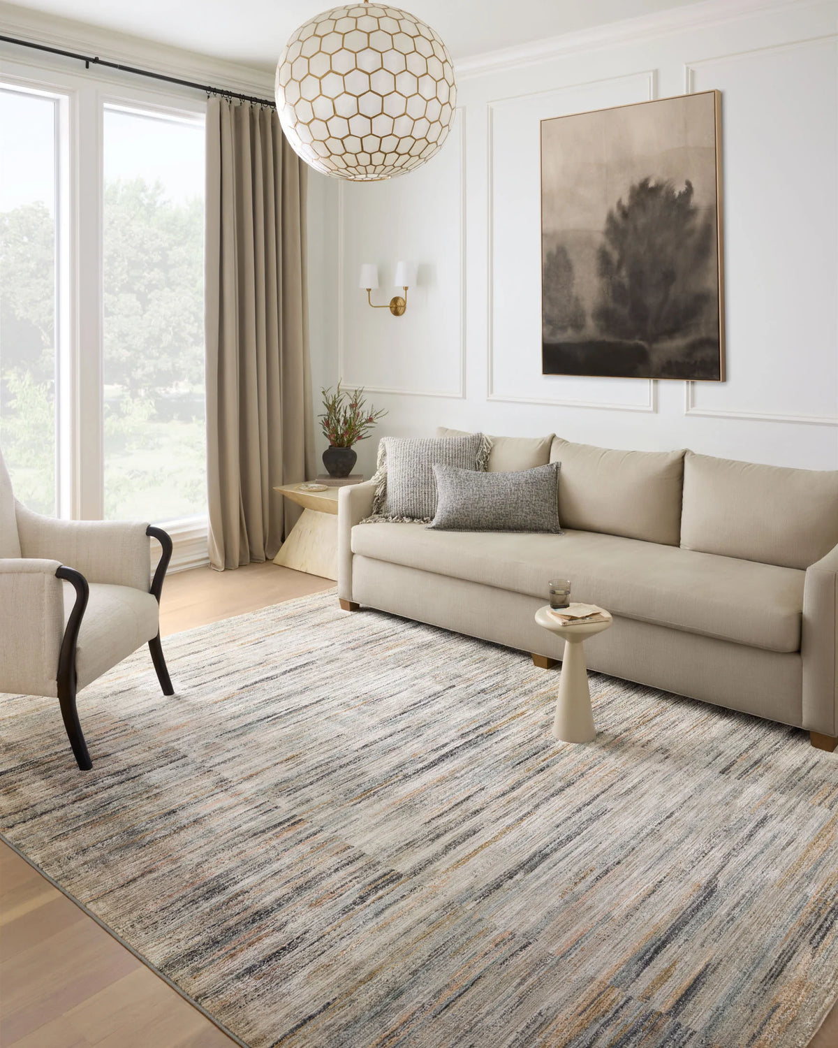 Area rug with multicolor linear stripe design in gray, blue, and tan; suited for living rooms.