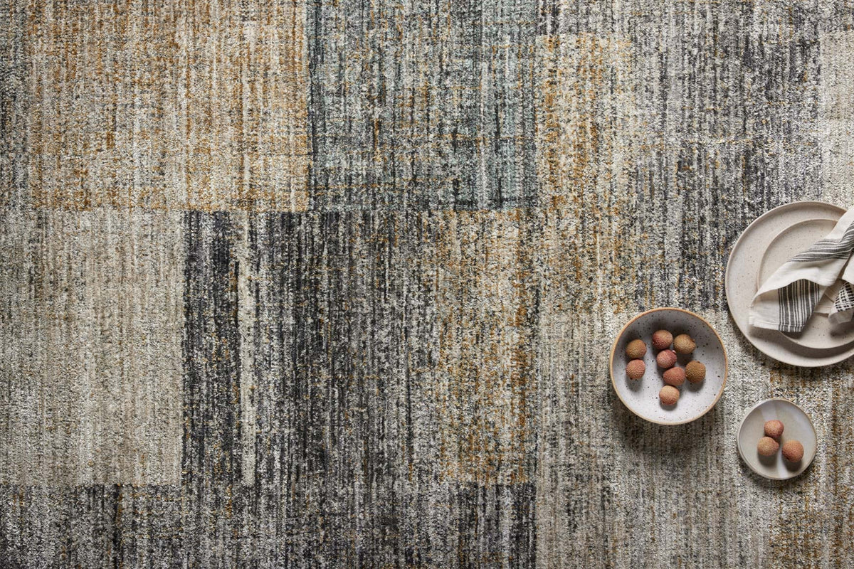 Close-up of grey and gold abstract runner rug with textured, multi-tone pattern.