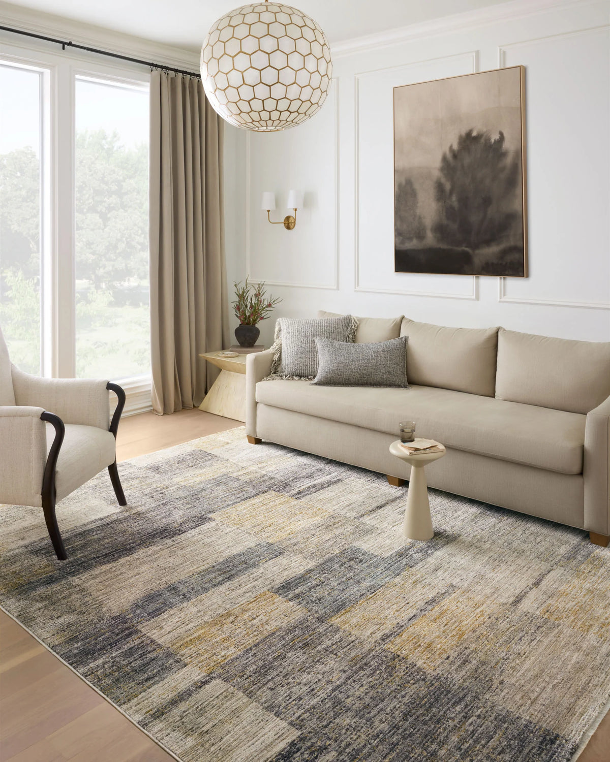 Grey and gold abstract runner rug laid in living room, visible corner and border.