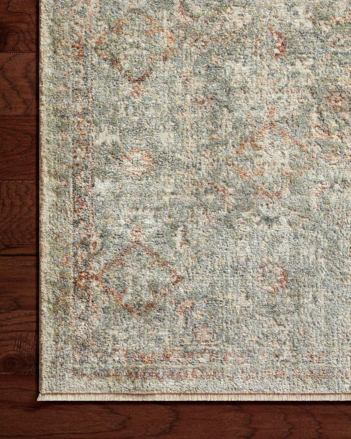 Textured speckled area rug with distressed motifs in lagoon blue, gold, and rust