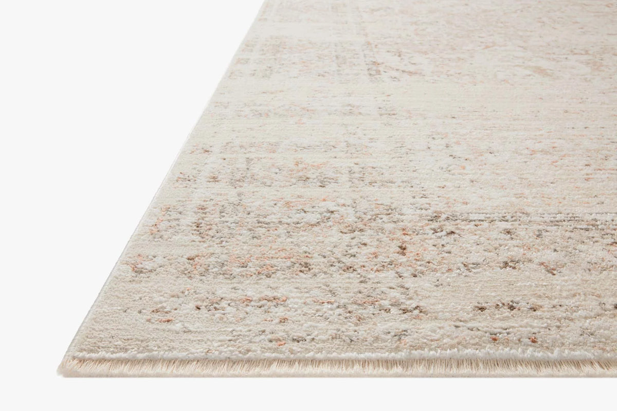 Loloi beige and terracotta area rug with short fringed edge and mottled texture