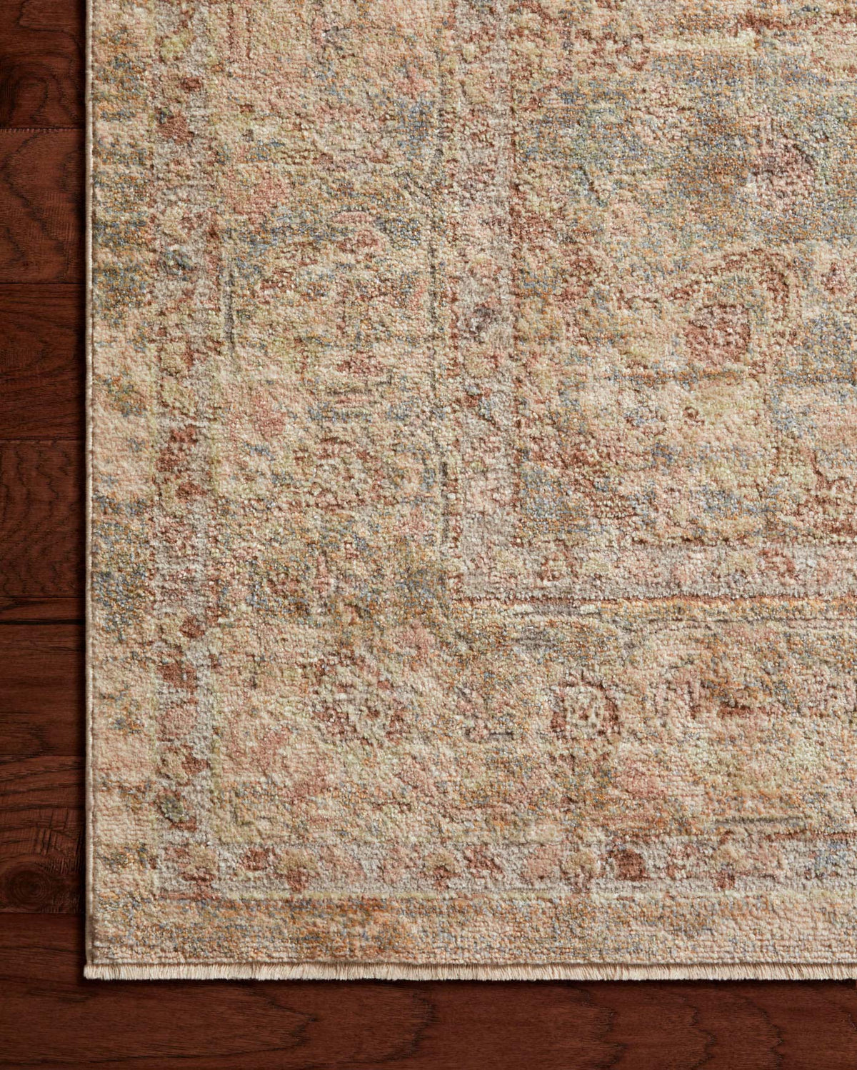 Mottled rectangular area rug in natural beige with moss green and warm rust highlights, flat weave
