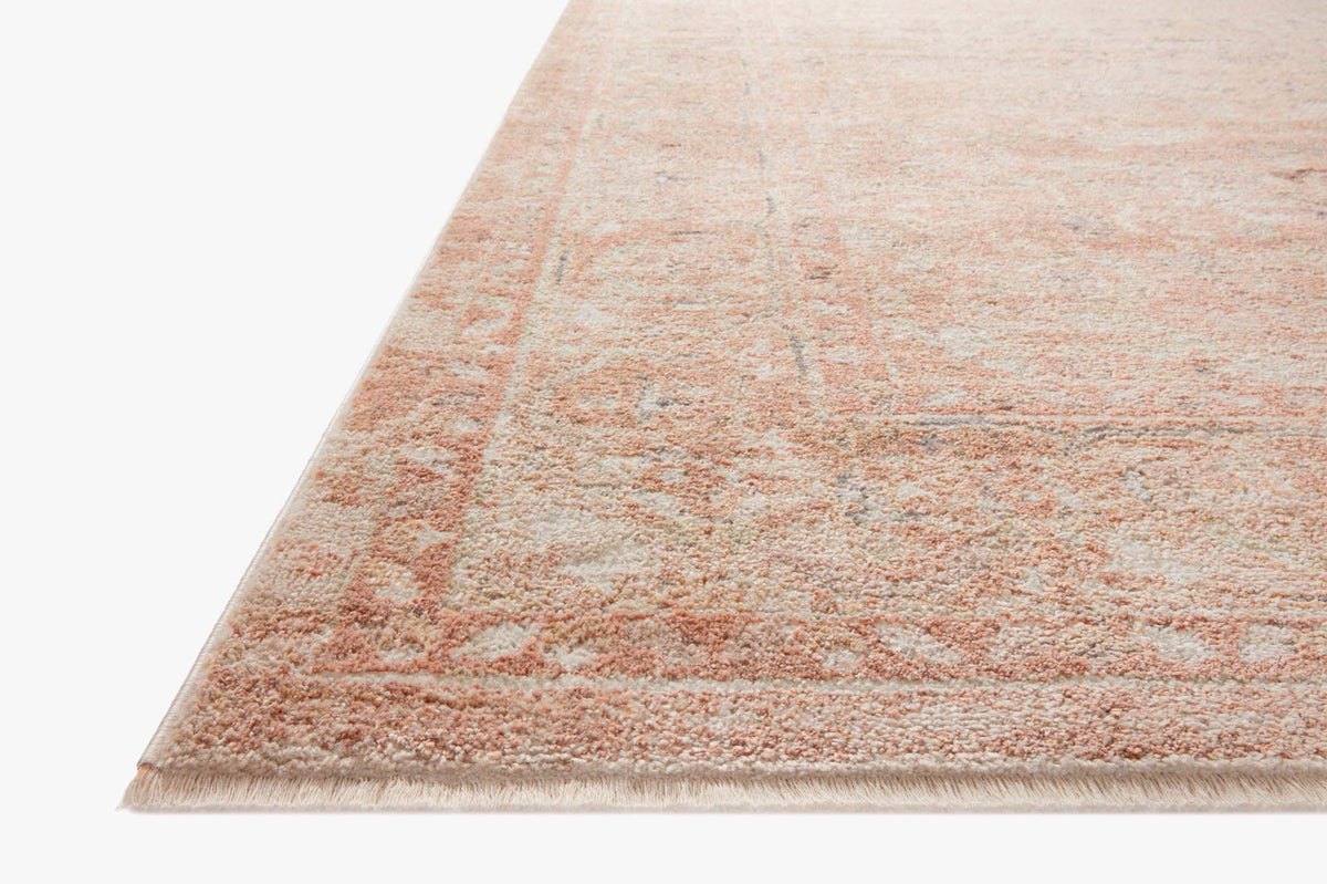 Terracotta and natural area rug with distressed pattern and fringe edge