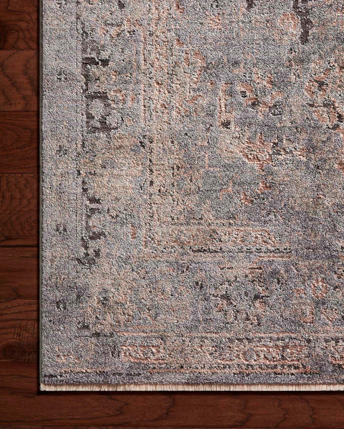 Charcoal and slate distressed abstract area rug on hardwood floor, low pile texture