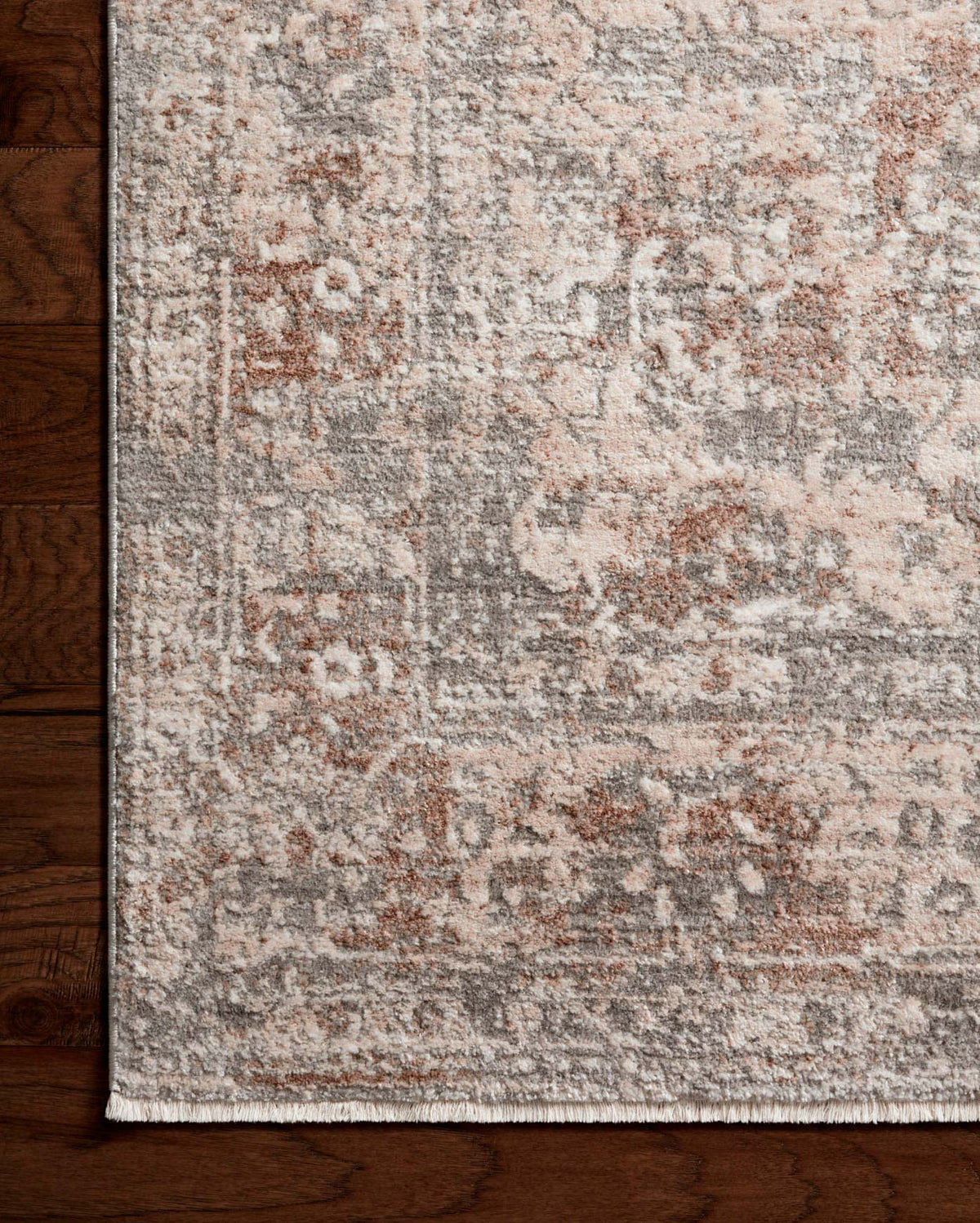 Close-up of silver and natural area rug with distressed pattern and textured short pile