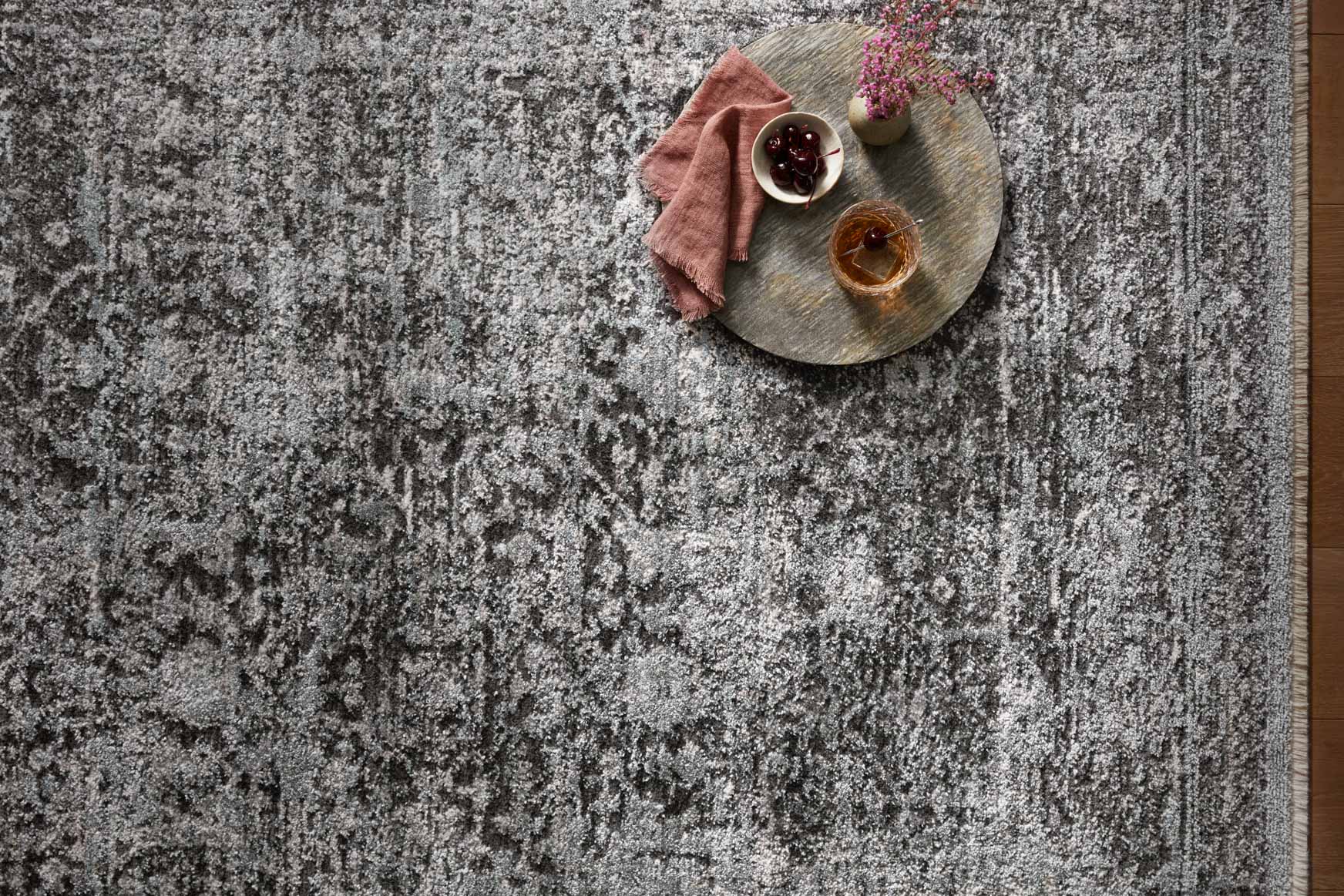 Textured charcoal runner rug with mottled pattern, close-up view
