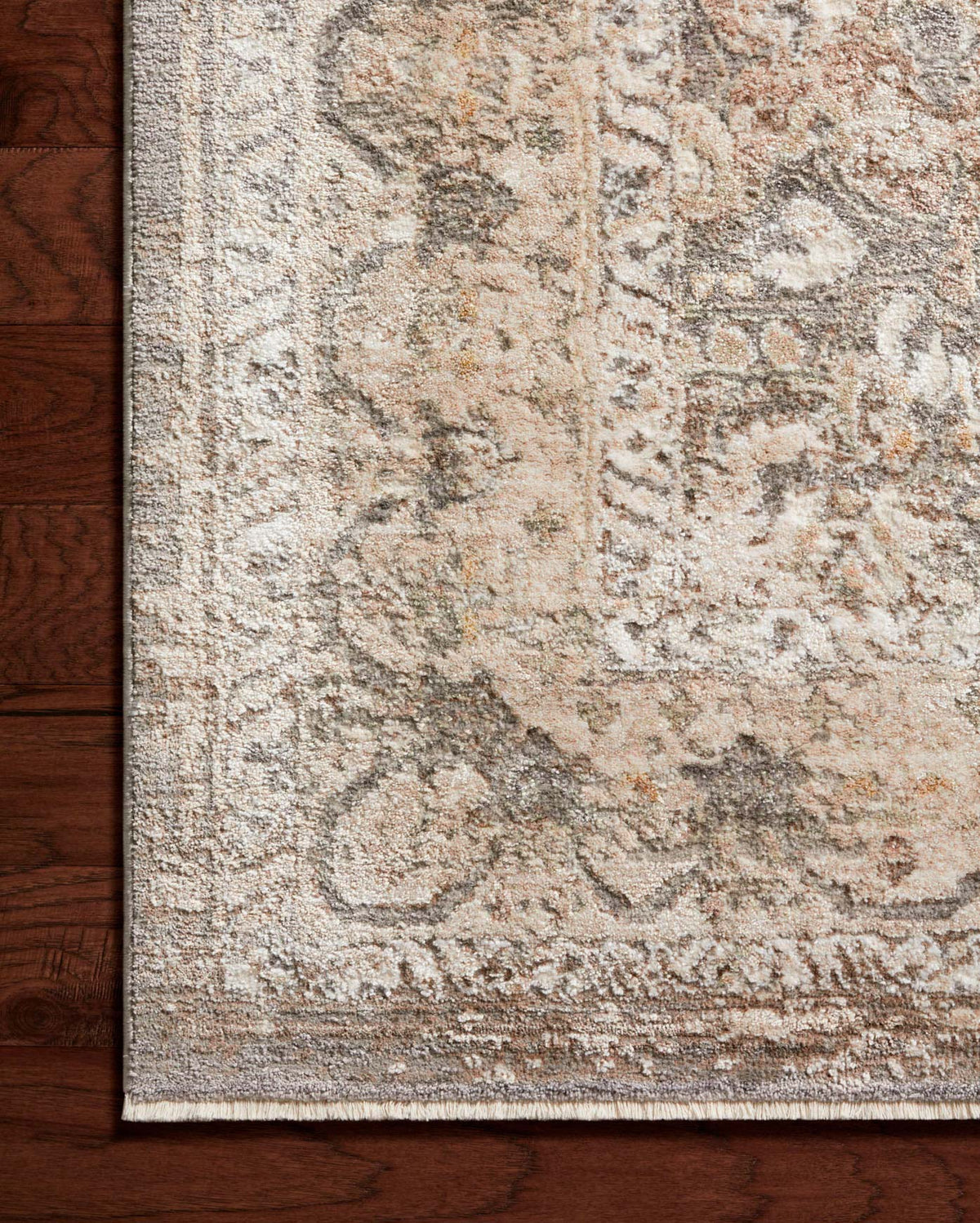 Gray and sage runner rug corner with dense distressed pattern and short cut pile.