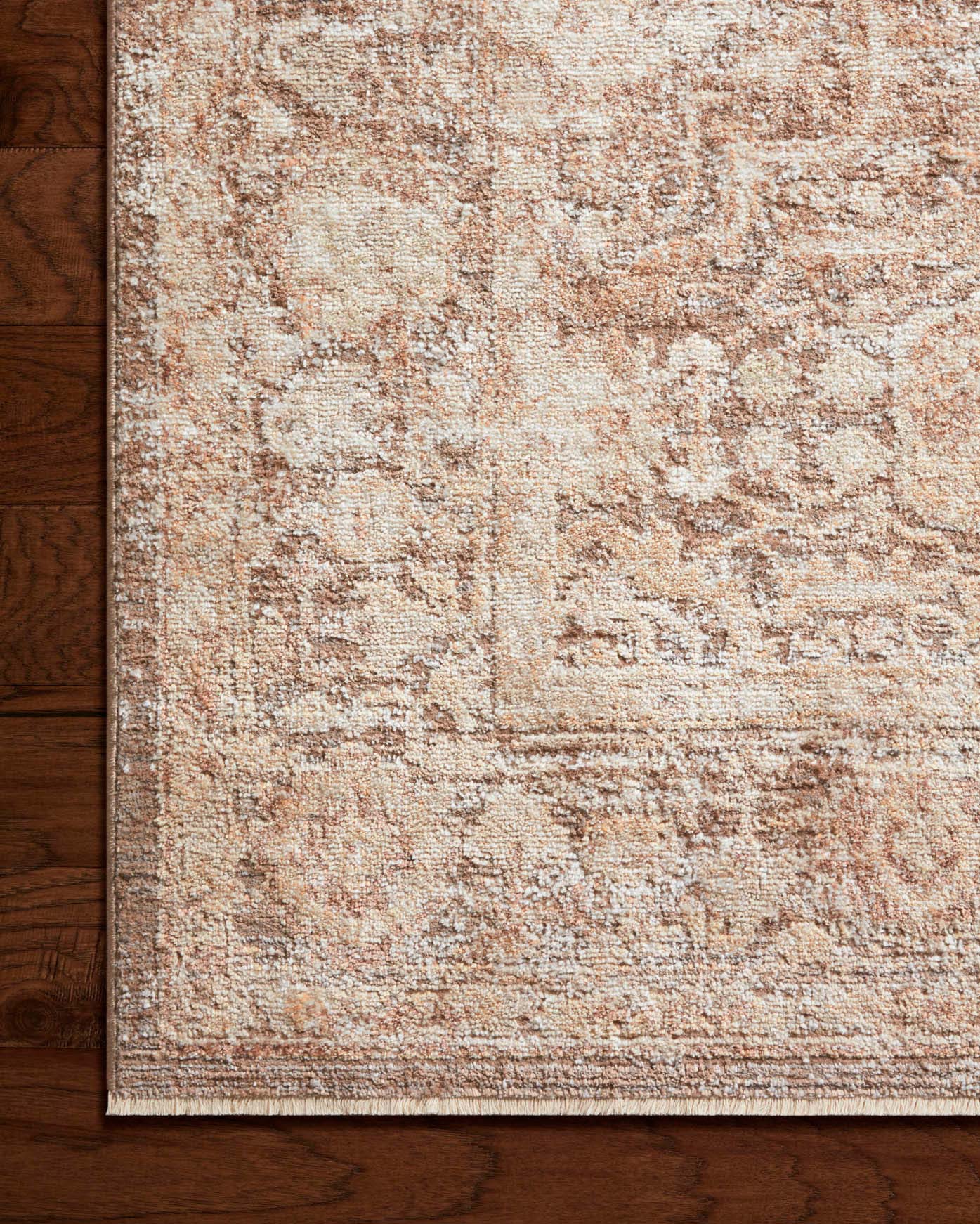 Textured runner rug in tan and mocha with distressed abstract pattern close-up