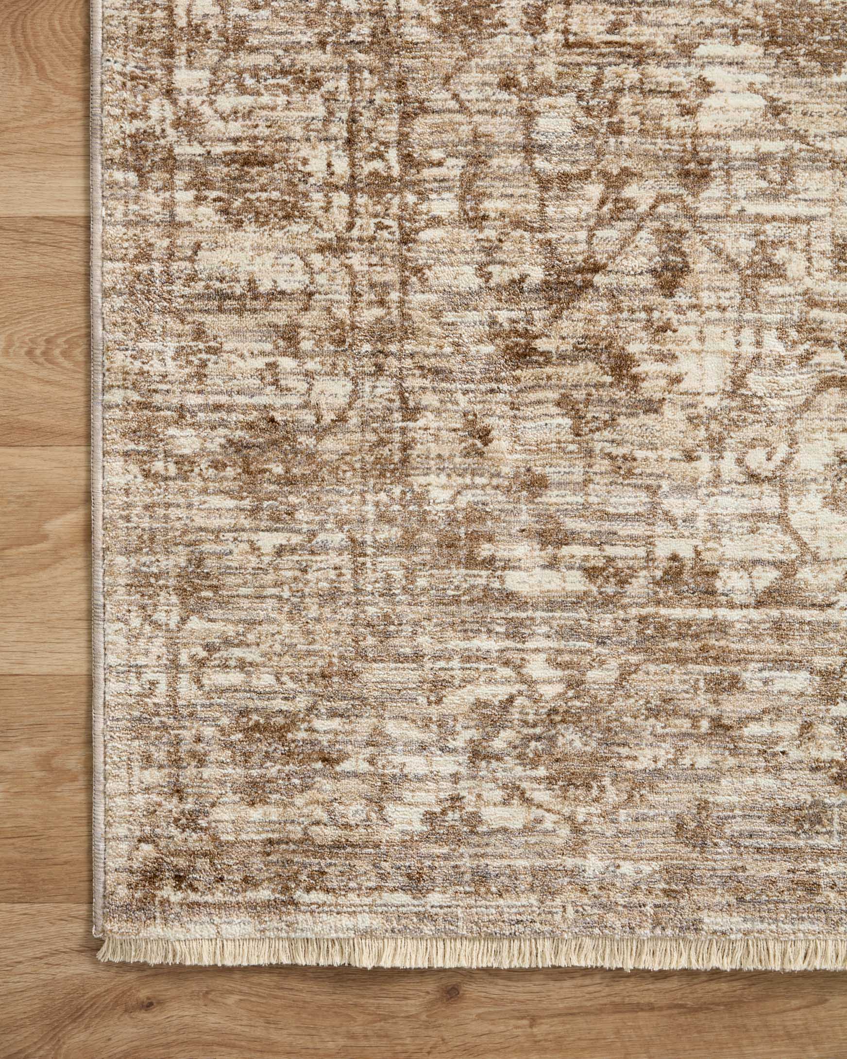 Traditional area rug with beige field, dark brown motif border, and short fringe