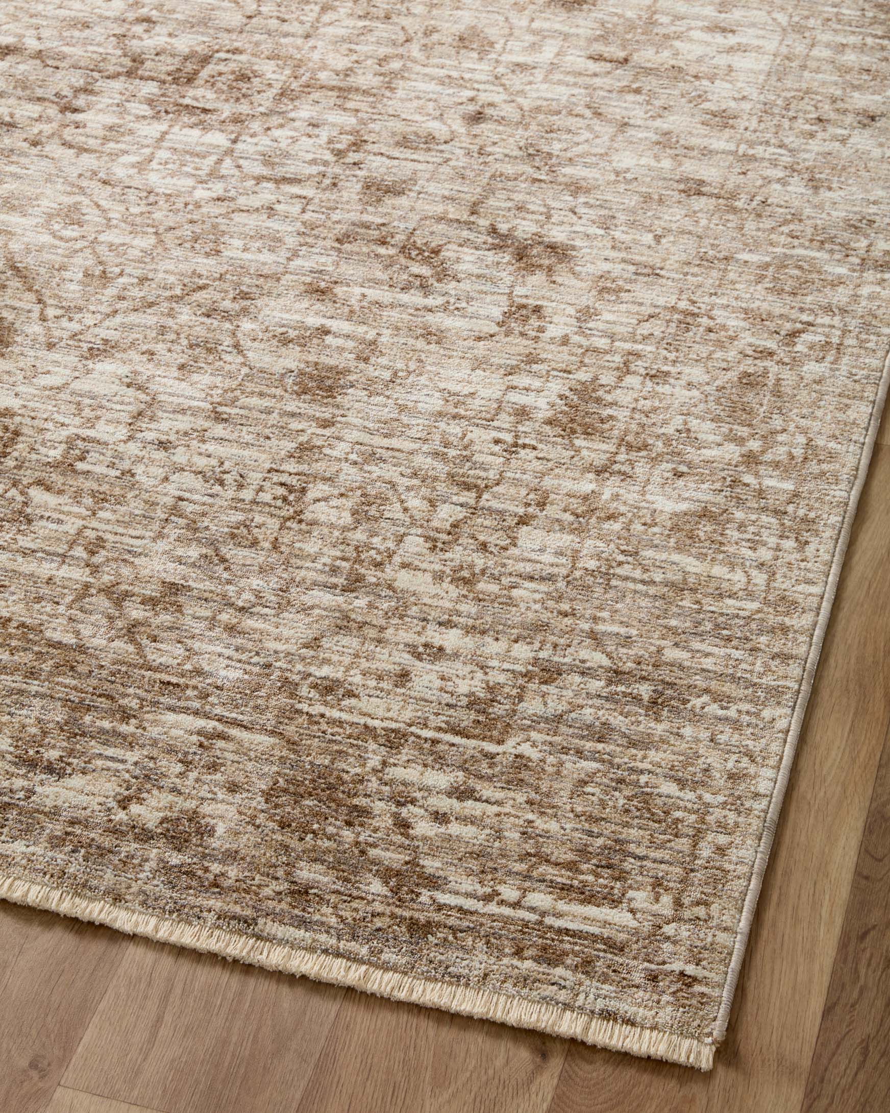 Close-up of runner rug surface with dense distressed texture in beige and bark brown.