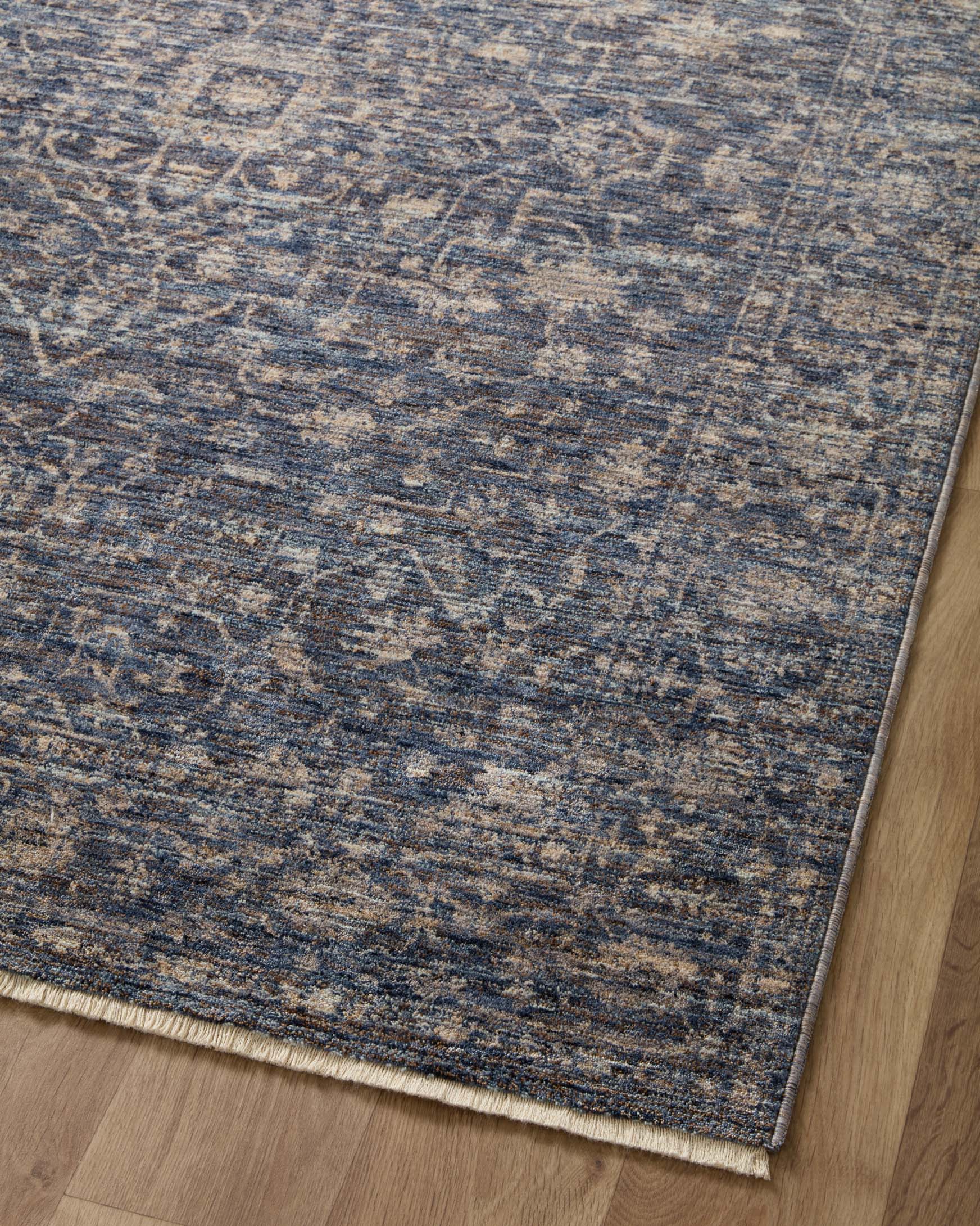 Traditional area rug surface with blue background and cream speckled motif pattern