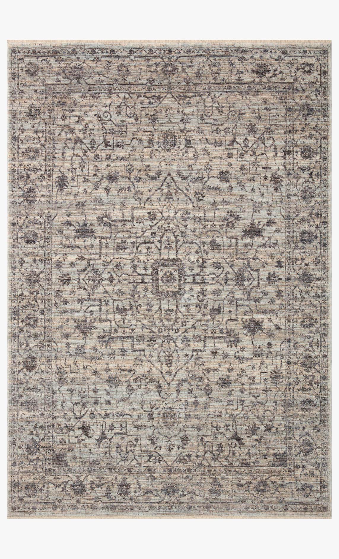 Light mist and charcoal area rug with ornate distressed medallion and geometric pattern.