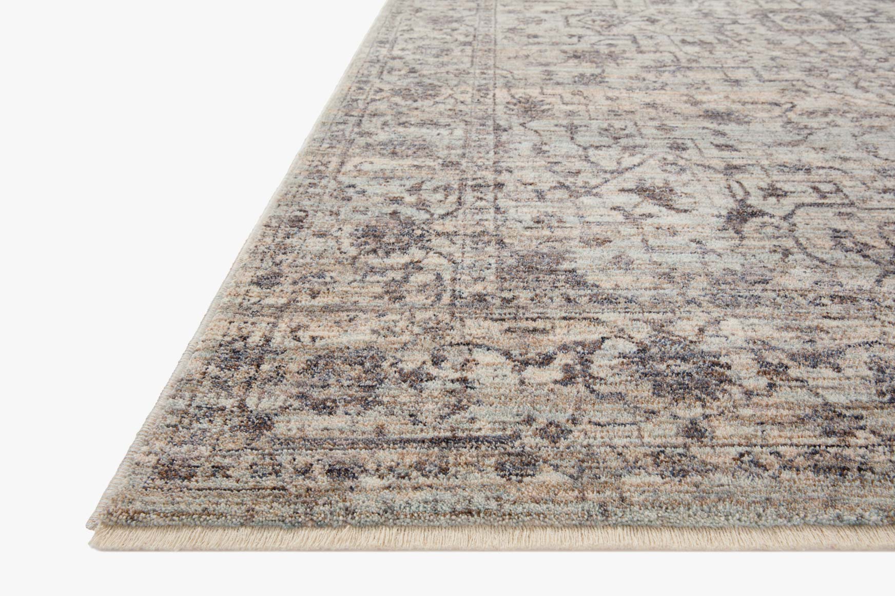 Mist and charcoal traditional area rug with distressed geometric design and bound edges.