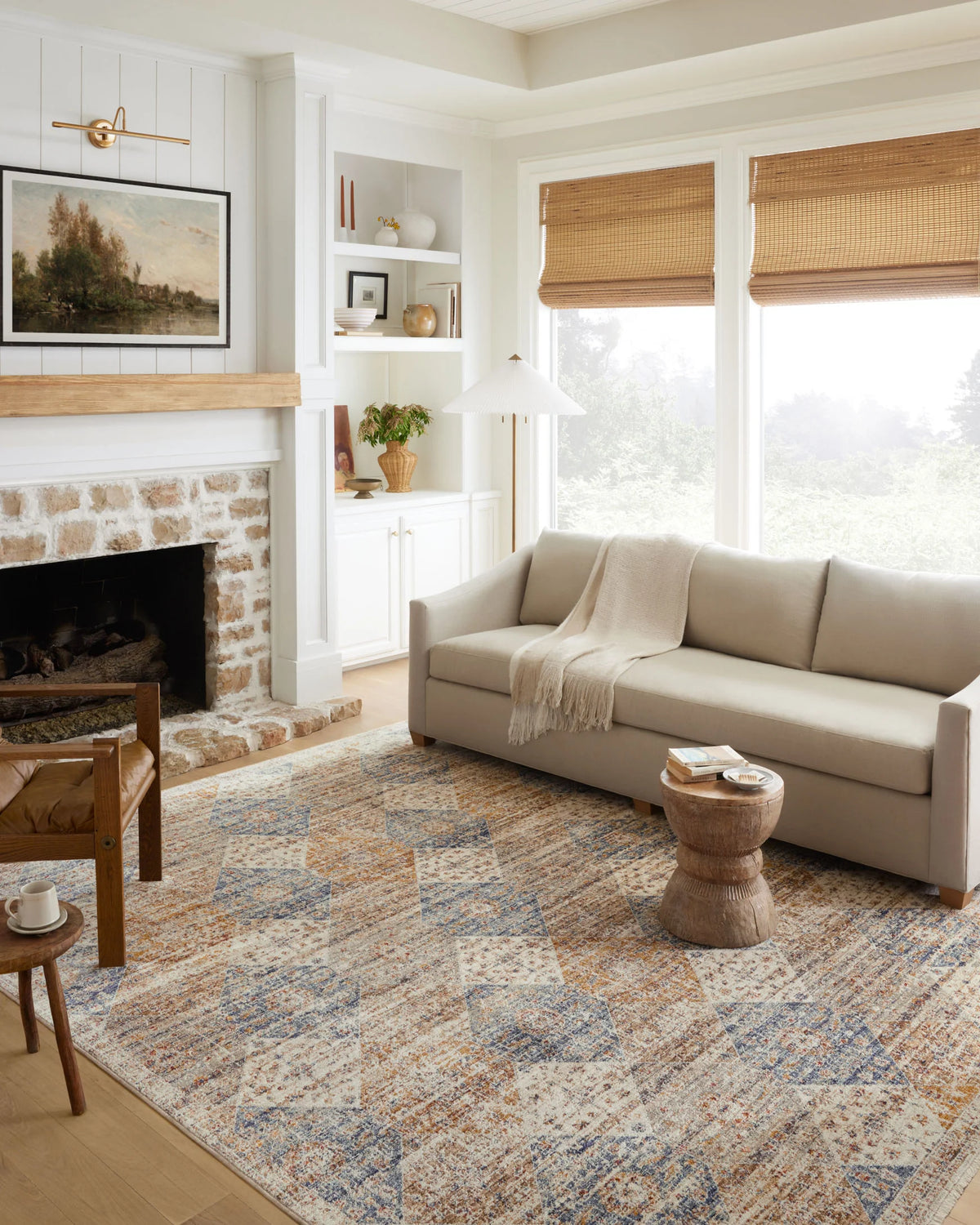 Traditional accent rug with ivory ground and blue-rust geometric pattern, fringed edges