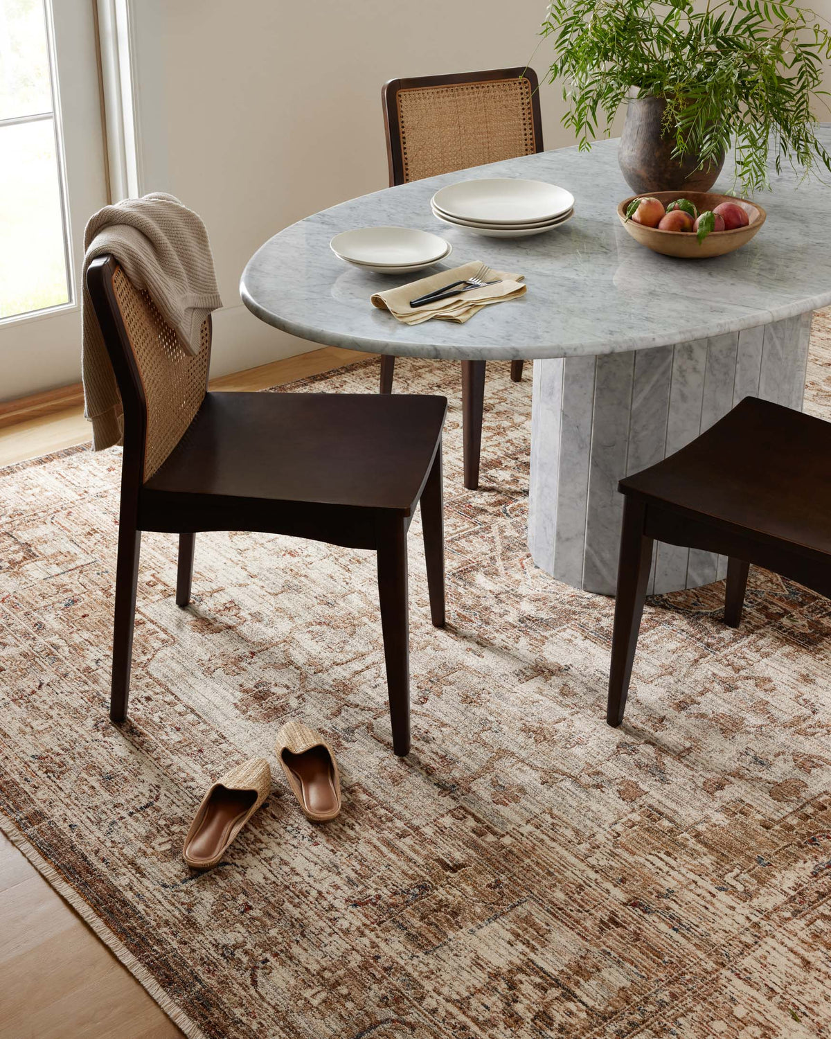 Round traditional accent rug in mocha and beige with distressed texture