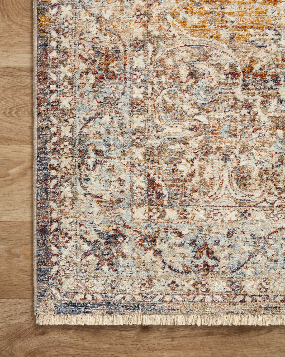 Beige multicolor traditional accent rug with ornate border and short fringe along edge