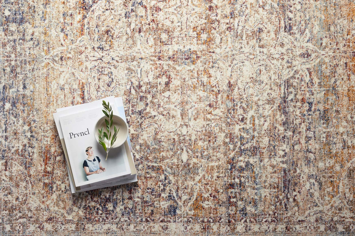 Beige traditional area rug with multicolor distressed motifs and dense textured surface.