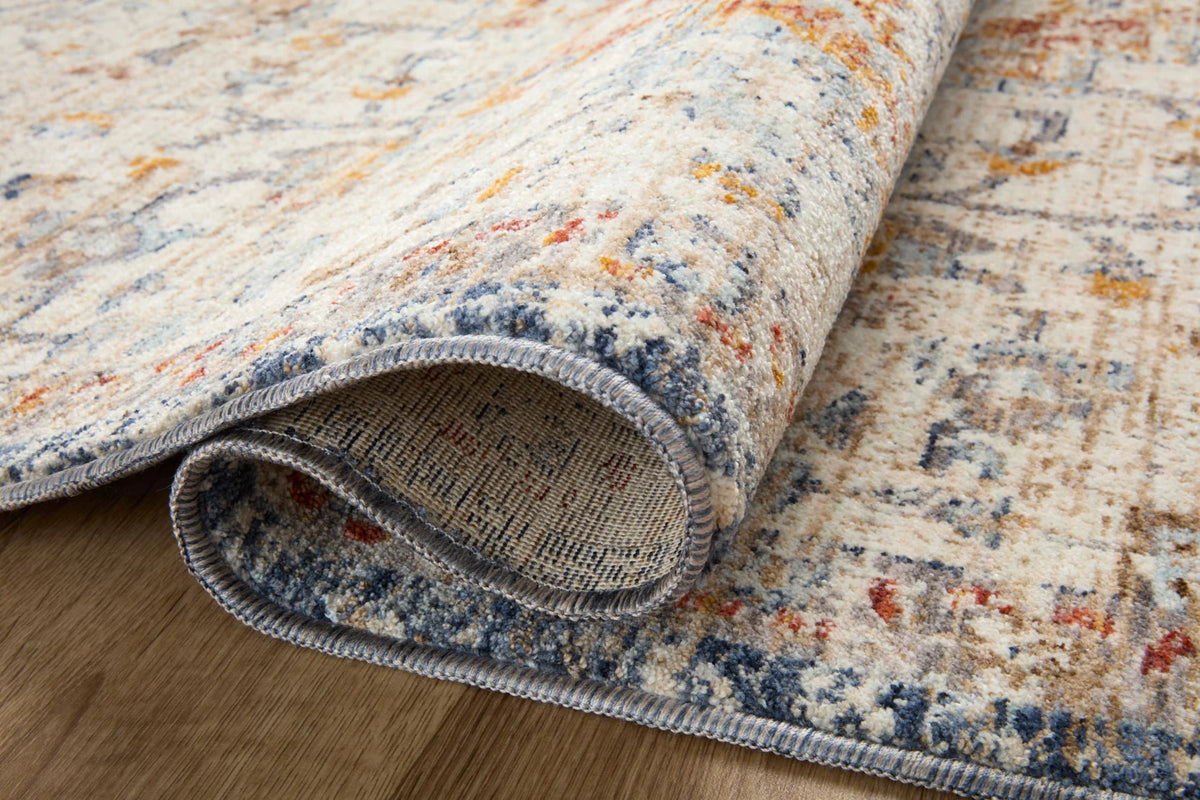 Ivory runner rug showing rolled edge with short fringed border in blue and orange threads