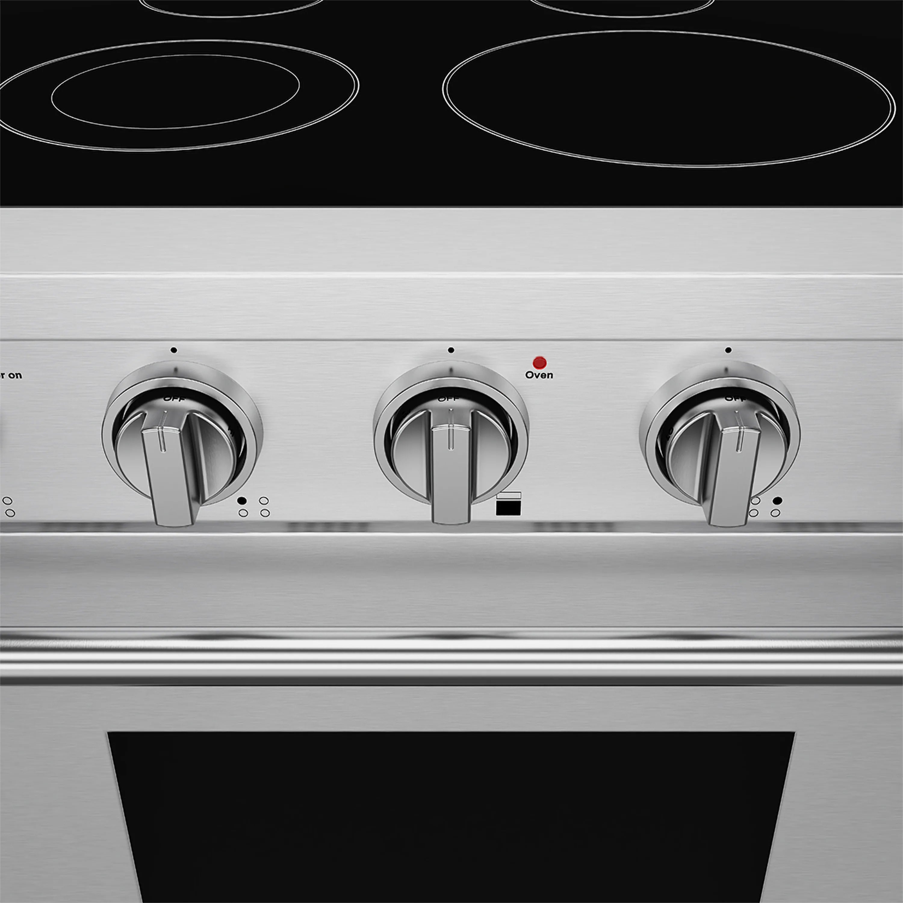 Stainless electric range control knobs and black cooktop surface with burner circles