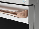 Rose-gold GSR oven handle on stainless gas range door, close-up