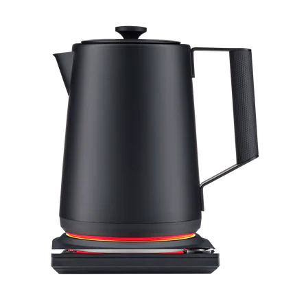Matte black electric kettle on base with glowing heating ring