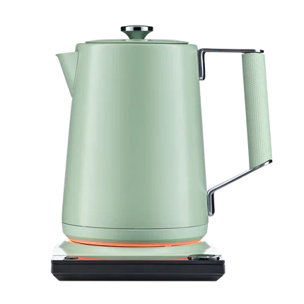 Sage green electric kettle on base with glowing heating ring