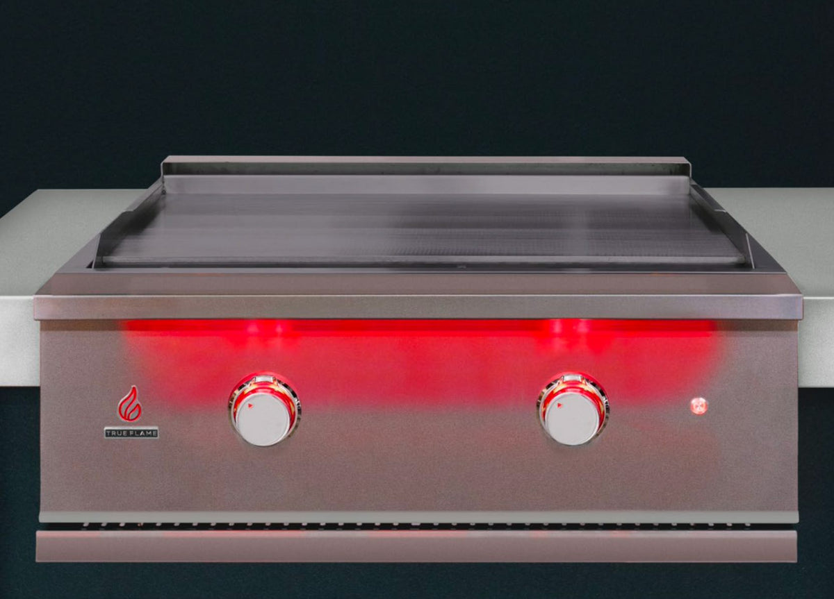 Built-in stainless gas griddle with red-lit burner panel and two control knobs