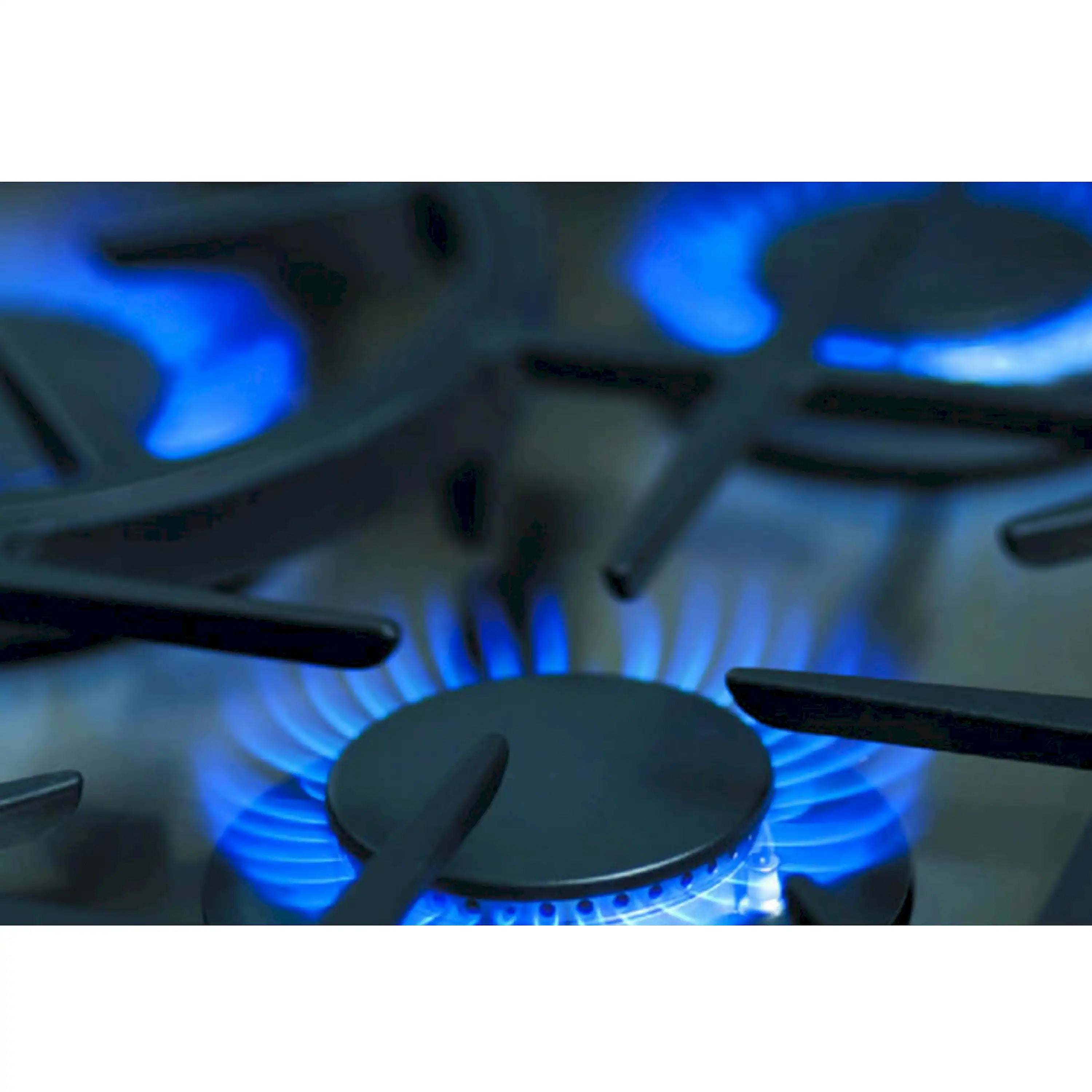 Close-up of black burner cap with blue gas flames