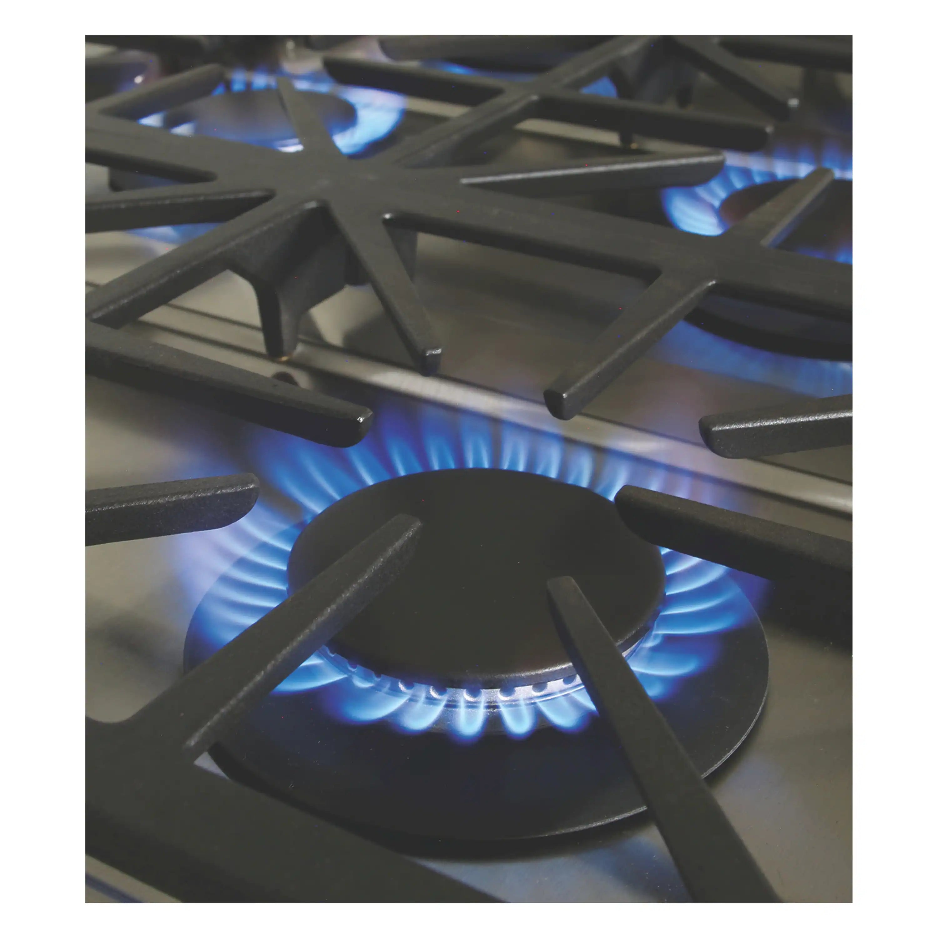 Black cast-iron burner grate over blue gas flame