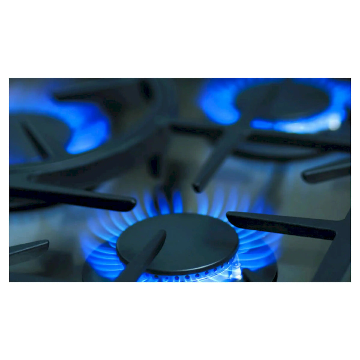 Close-up blue flame from a gas burner under a black grate