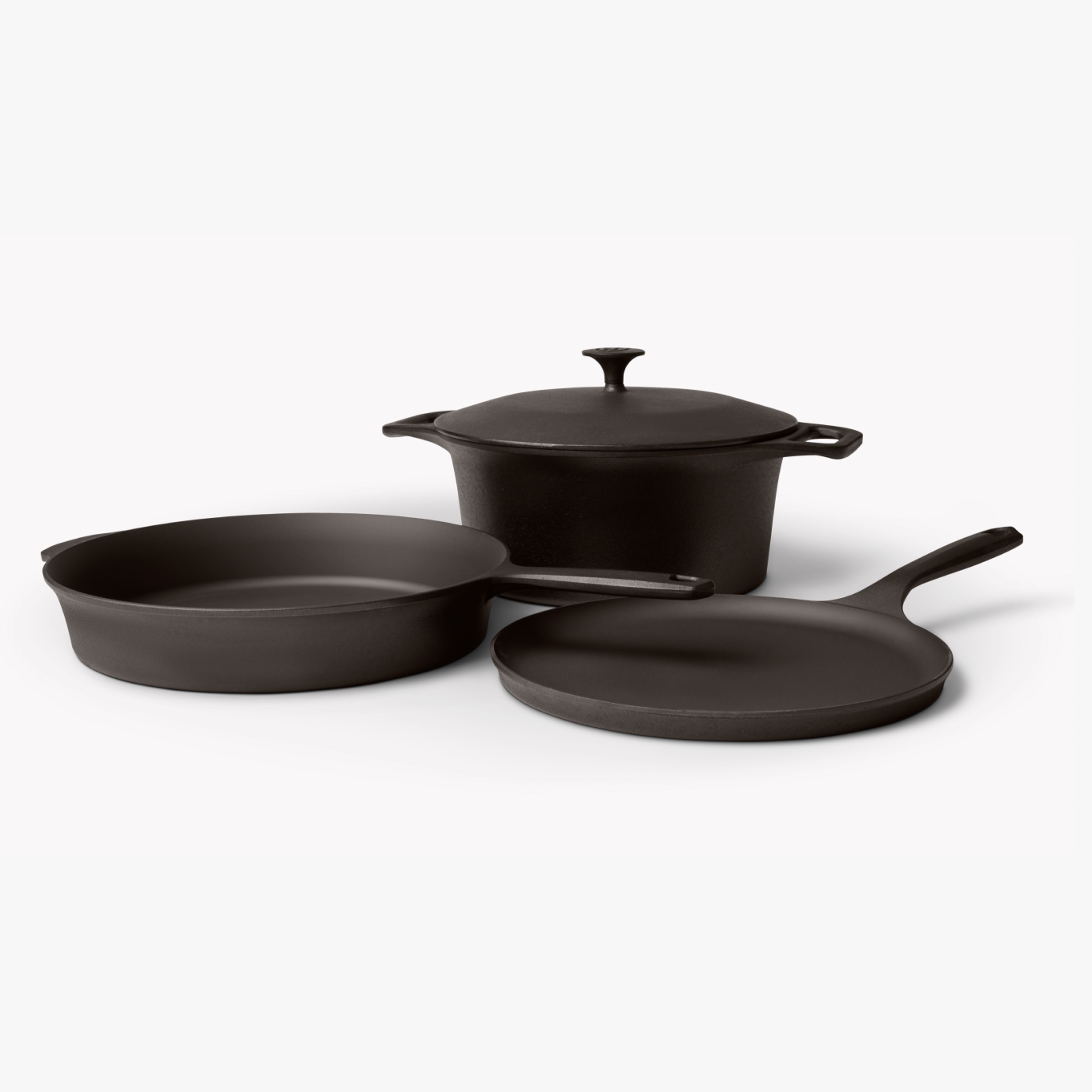 Black cast iron cookware set with pot, lid, skillet, and grill pan—4 pieces