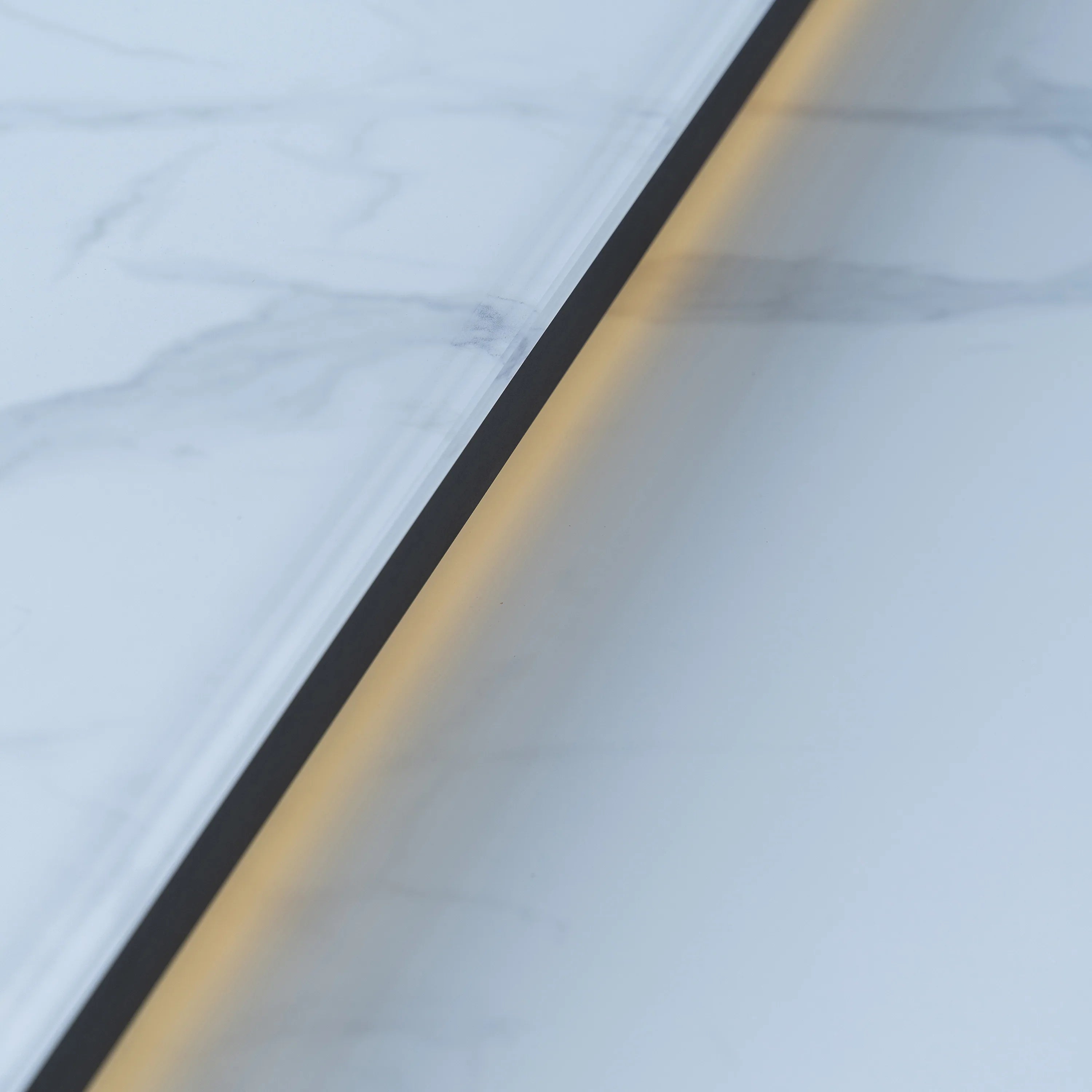 Smart dining table edge detail with dark trim along marble-look white tabletop
